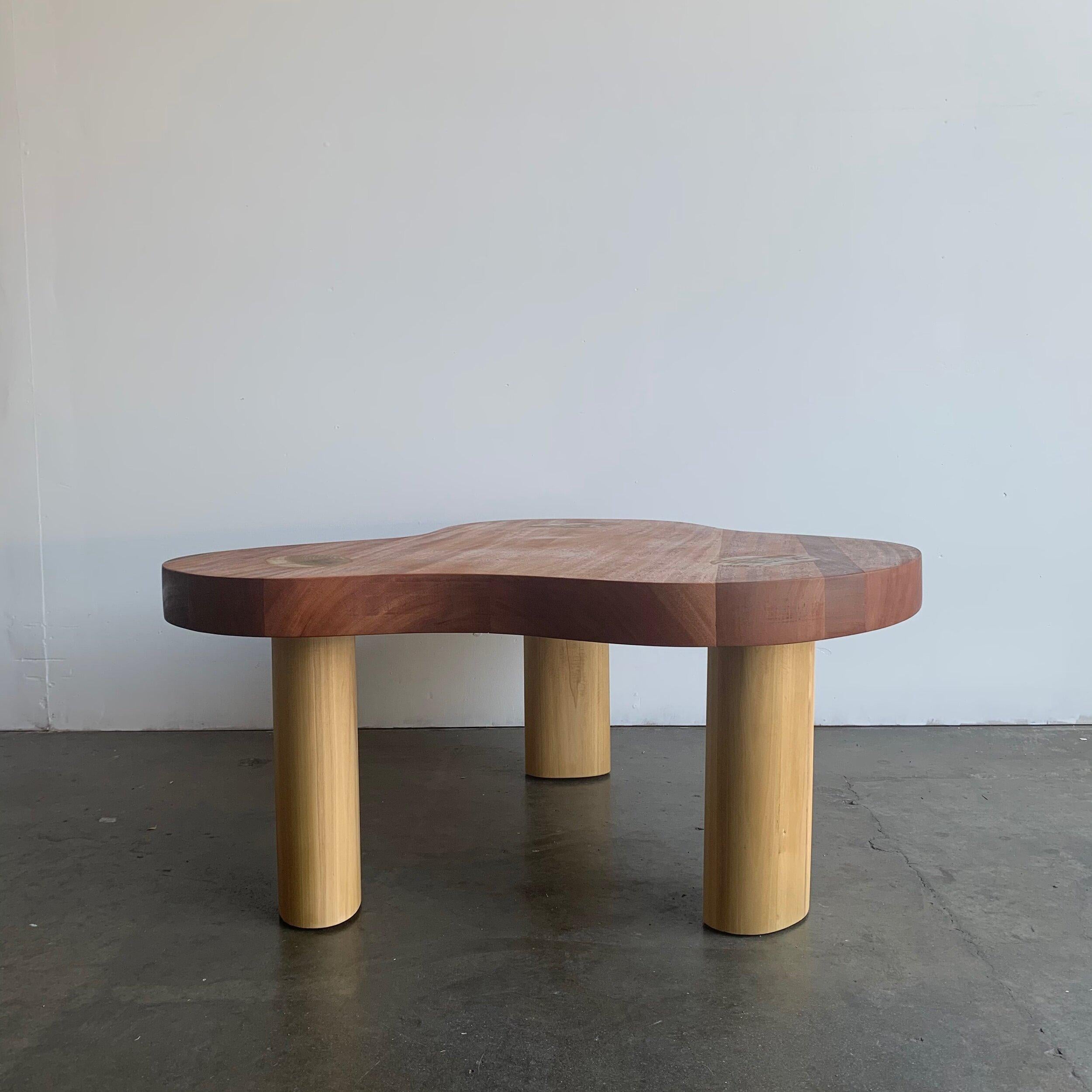 Handcrafted coffee table by Vintgae On Point. Made in Solid Mahogany with solid poplar legs. This coffee table offers a great amorphous shape with legs that are exposed all the way to the surface. Coffee table has a clear coat finish with NO stain