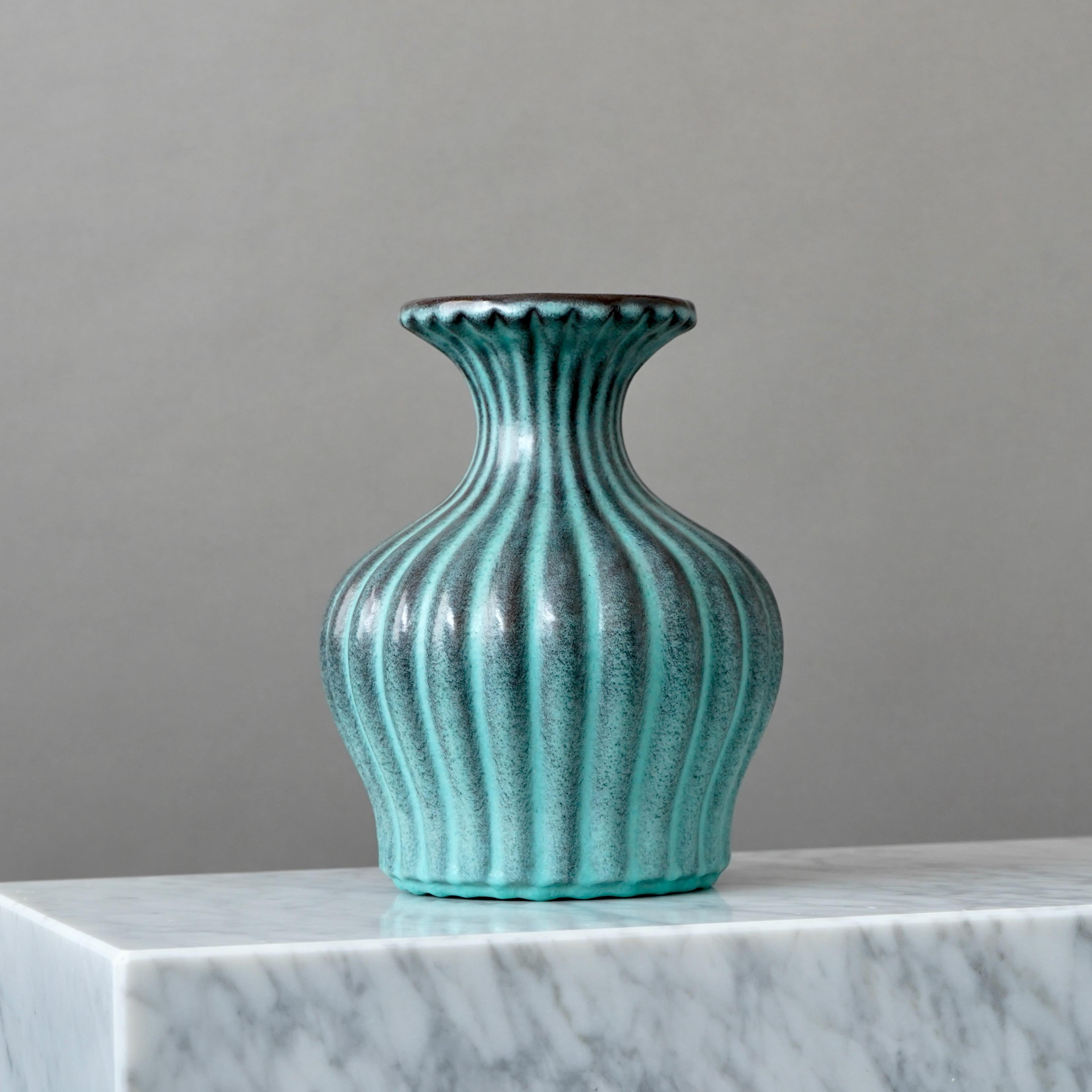 A beautiful fluted Art Deco vase with amazing 'Lava' glaze. 
Designed by Ewald Dahlskog for Bo Fajans (Bobergs Fajansfabrik), Sweden. 

Excellent condition. 
Impressed signature 'ED' and makers marks on base of vase. 

Ewald Dahlskog (1894-1950) was
