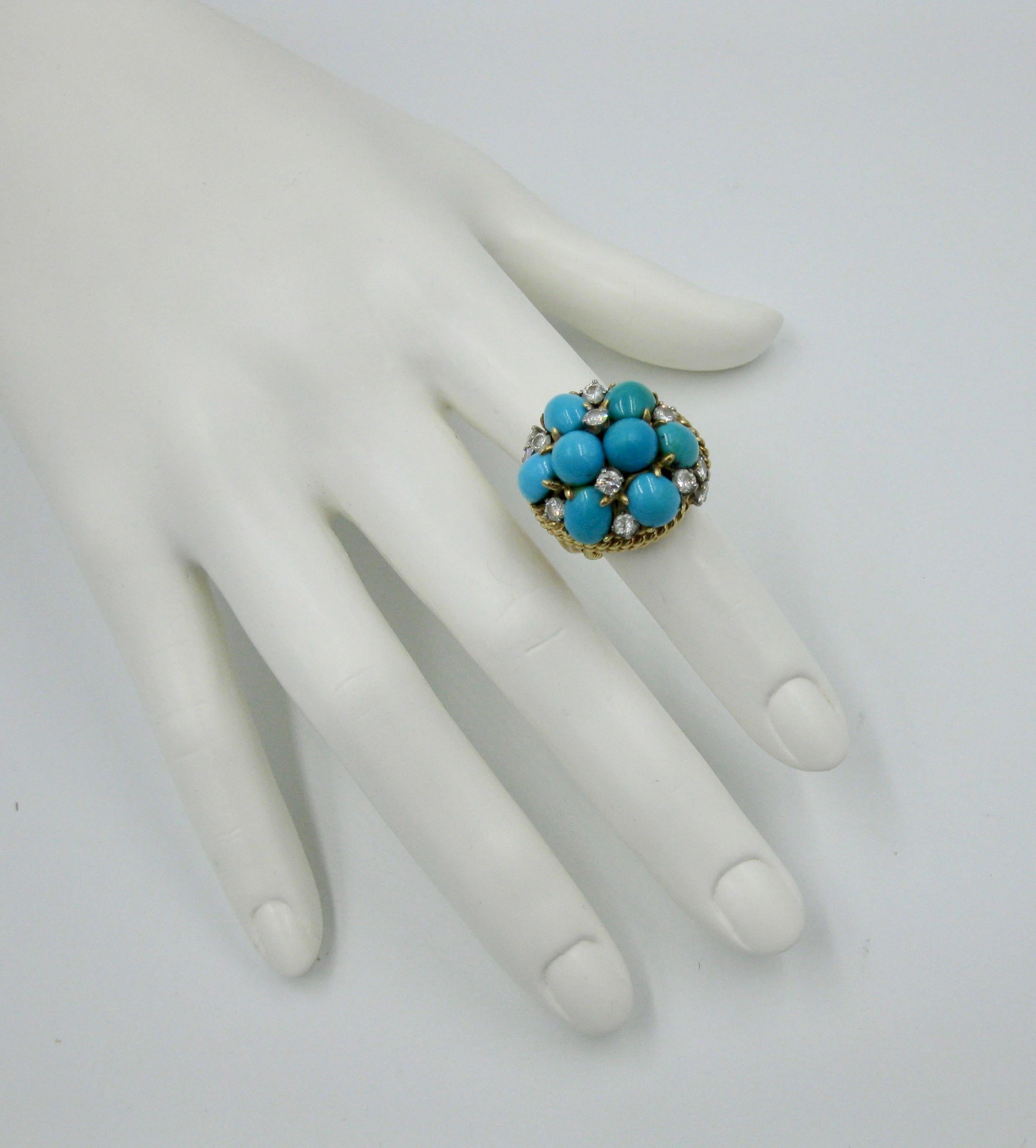 This is a magnificent Persian Turquoise Diamond Ring.  The jewel is set with eight gorgeous Persian Turquoise oval and round cabochons of great beauty.  The ring is further set with 12 sparkling white Diamonds scattered throughout the blue of the