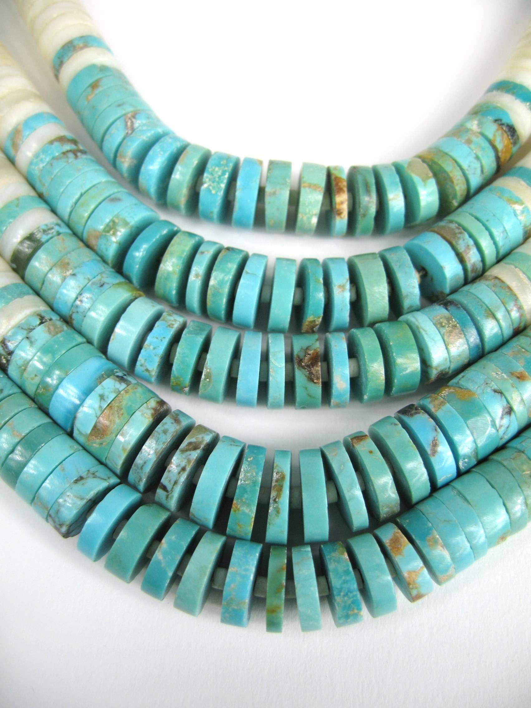 Stunning 5 strands Heishi Necklace with discs of graduated Turquoise and shell 11.66 mm down to 4mm attached to large Turquoise stations then onto more turquoise beads. Sterling silver finding at the end. The necklace is strung on original string.