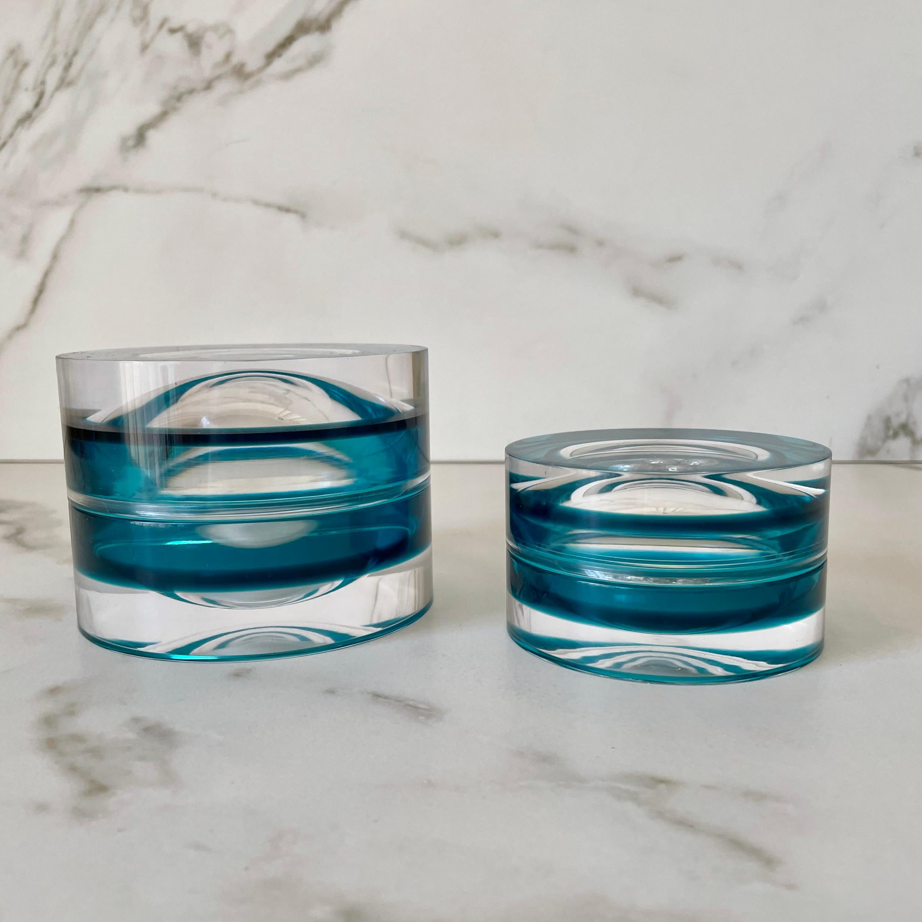 Modern, colorful and fun round box that can be used as a decorative element on a coffee table, desk or nightstand. Serving double duty as a storage box or as a candy bowl. 
They look beautiful when you pair the two available sizes.

Material: