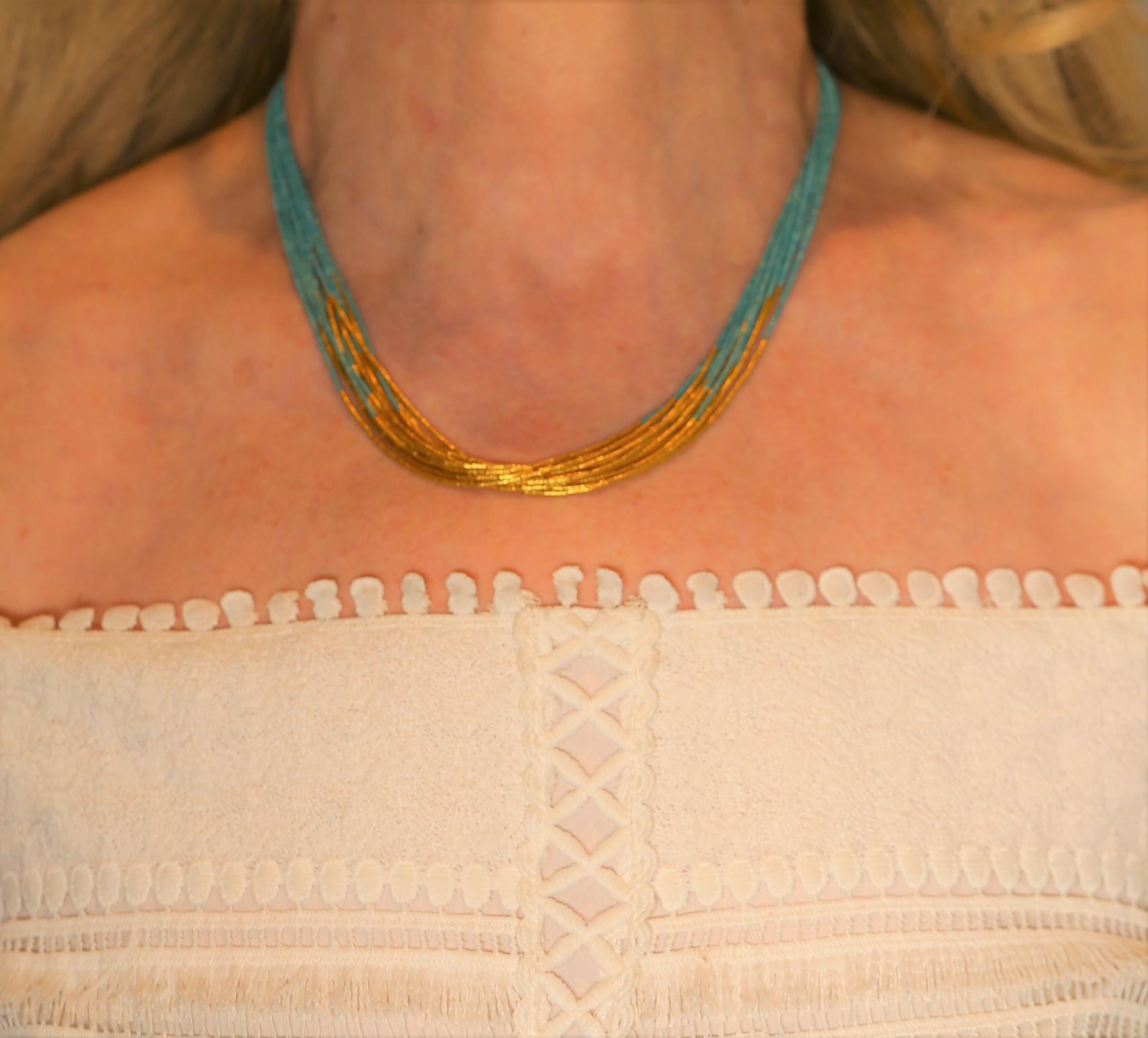This twelve strand natural Afghan turquoise necklace features a eye catching 24 karat yellow gold 