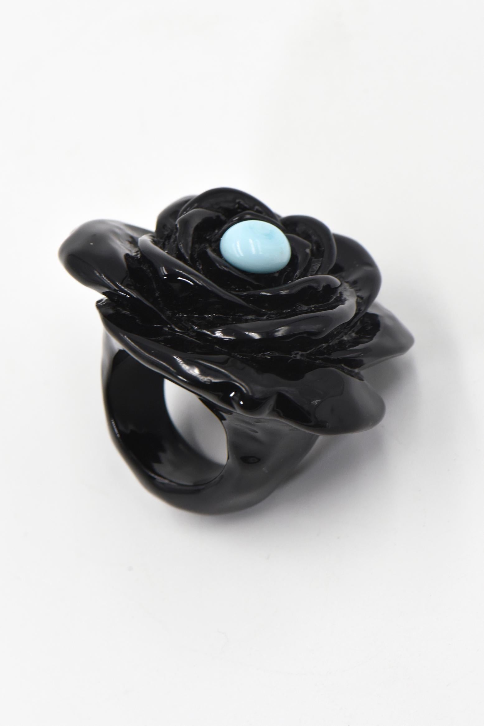 Black acrylic flower ring with a cabochon turquoise in the center. U.S. size: 10