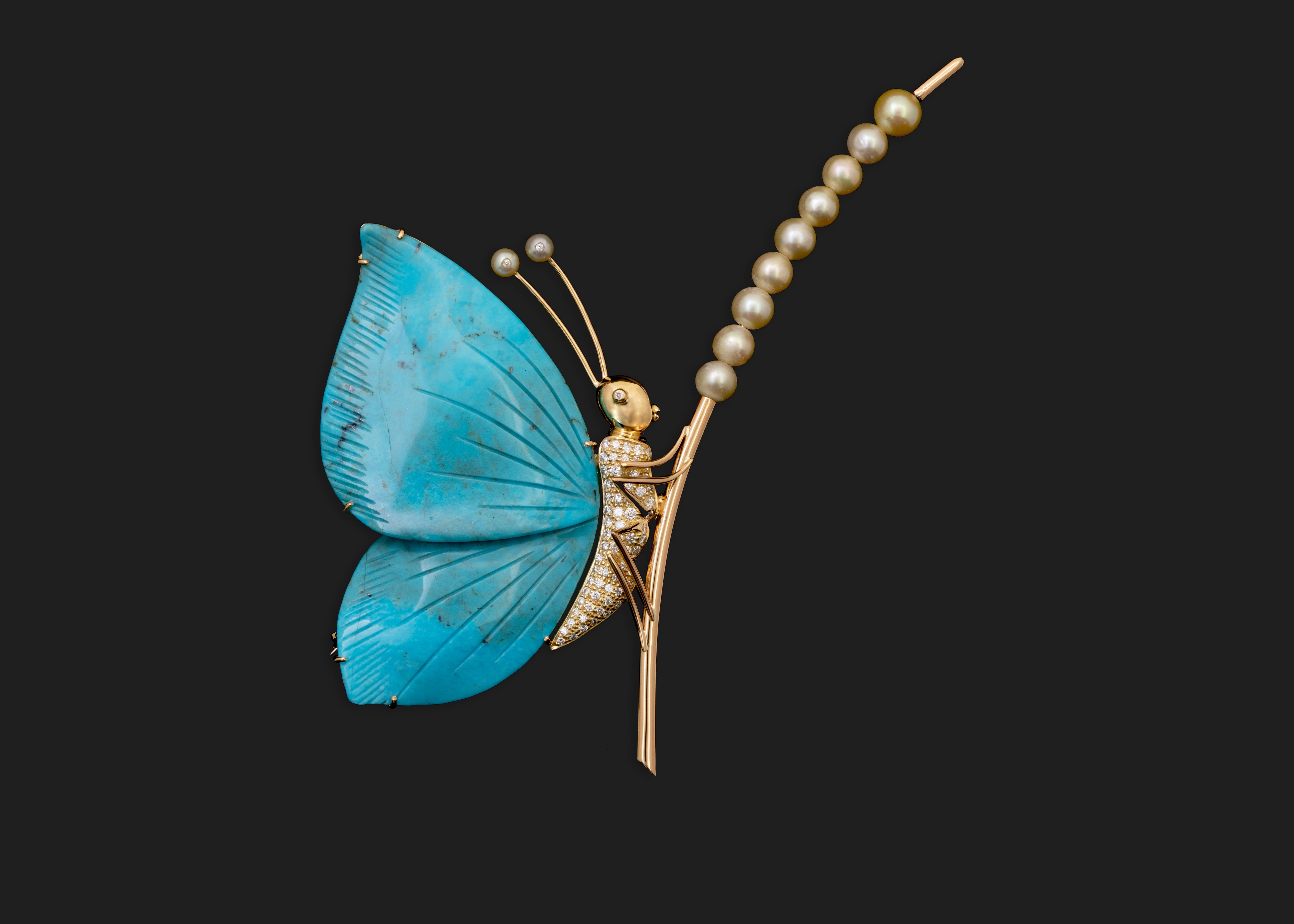 This uniquely carved turquoise stone resembling a butterfly's wing was the inspiration behind this showstopper Brooch.
An 18k yellow gold, diamond studded butterfly stands with glory on a branch of near round Bahraini Pinctada Radiata pearls.

*