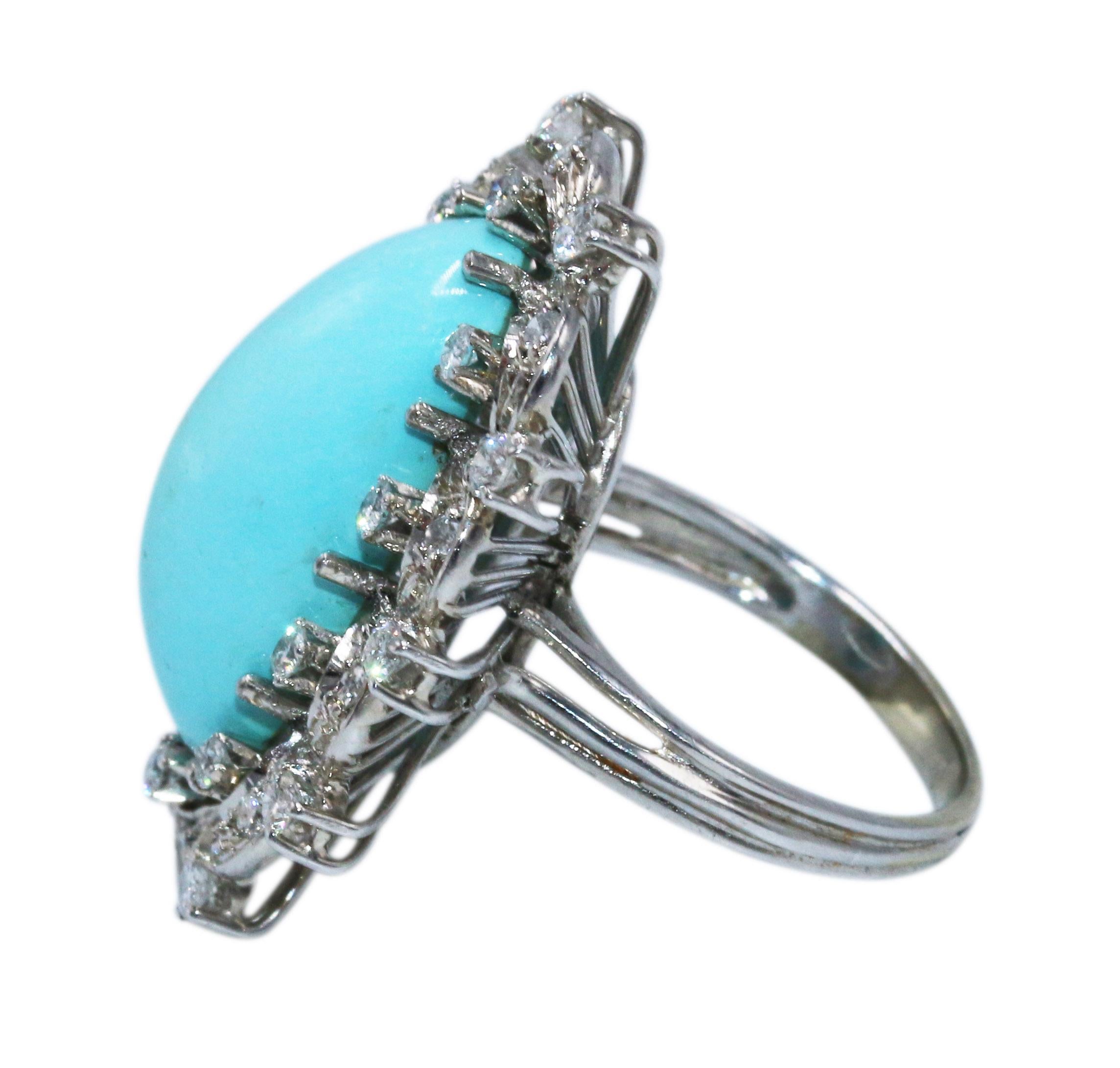 18 karat white gold, turquoise and diamond cocktail ring, set in the center with a sugarloaf cabochon turquoise measuring approximately 21.2 by 10.1 by 8.0 mm., framed by round diamonds weighing approximately 0.50 carat, size 6 1/2.
A gorgeous ring