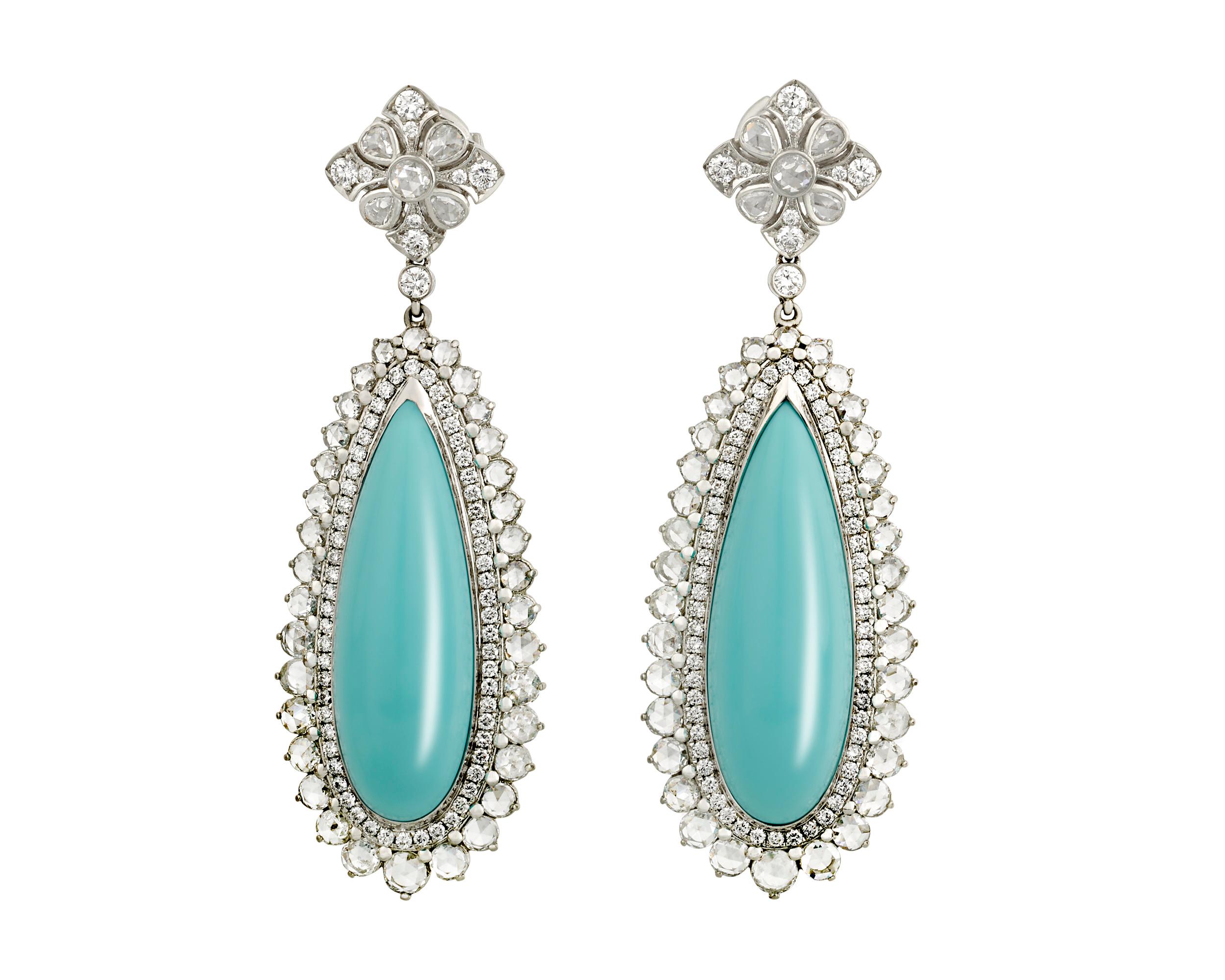 The cool blue of turquoise is accented by the drama of sparkling diamonds in these classic Tiffany & Co. earrings. The turquoise stones, totaling 23.77 carats and displaying Tiffany's signature blue hue, dangle elegantly in their platinum setting