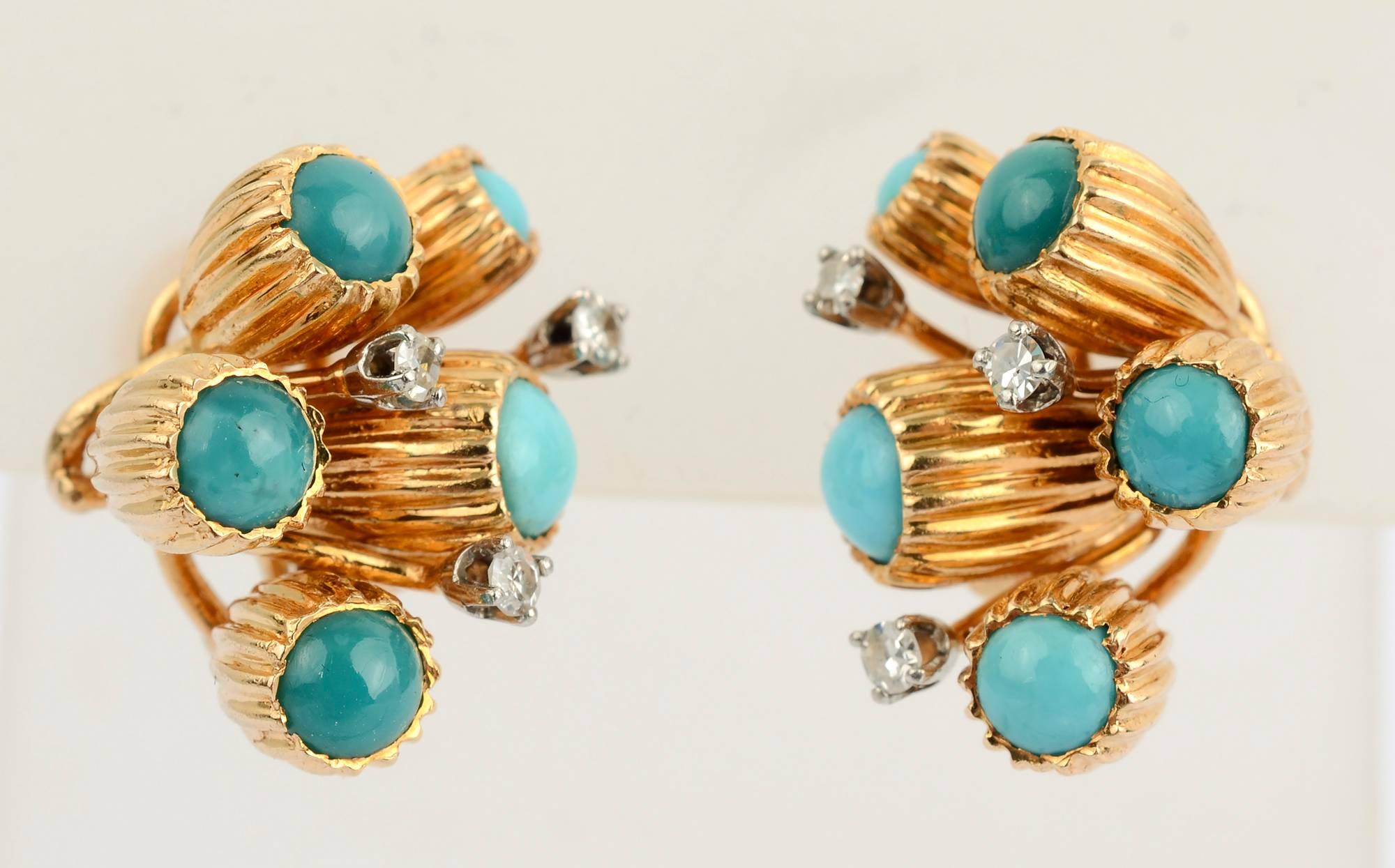 Unusual earrings with clusters of turquoise stones that are set in elongated, ribbed cups, perhaps meant to be bellflowers. In addition to five turquoise stones, each earring has three diamonds. Backs are clips and posts. 