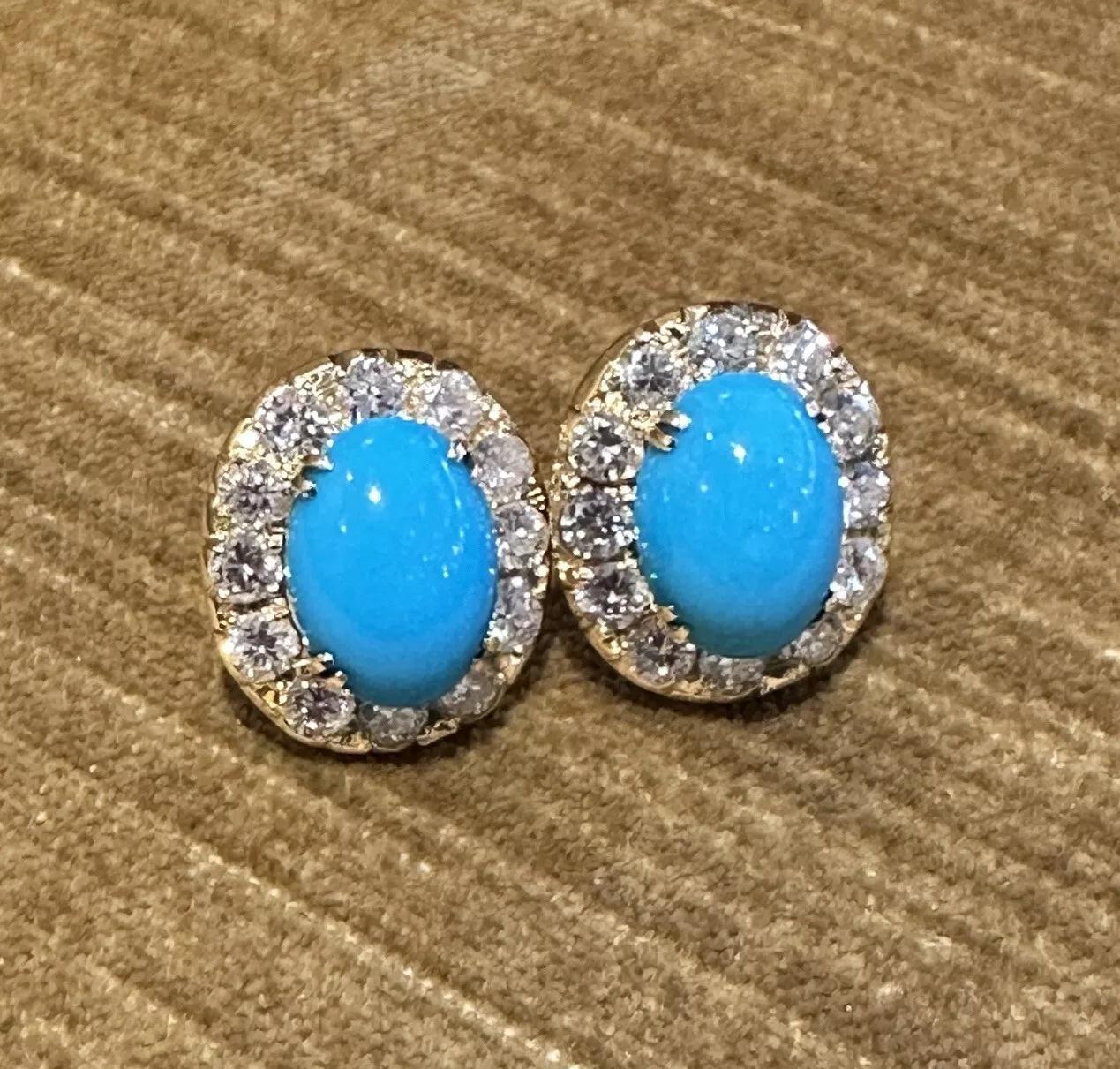 Turquoise and Diamond Halo Button Earrings in 18k Yellow Gold 

Turquoise and Diamond Earrings features 2 Natural Oval Turquoise Cabochons, weighing 4.40 and 4.68 carats, surrounded by a halo of 12 Round Brilliant Diamonds on each earrings, all set
