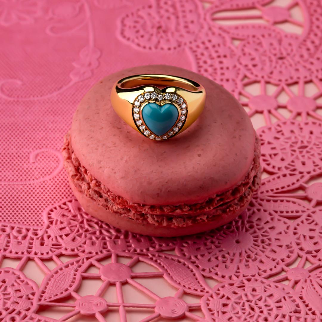 This pinky signet ring is crafted in 18kt yellow gold and set with a lustrous natural heart shaped 1.47 ct. turquoise from the Sleeping Beauty Mine in Arizona. A perfect coupling of turquoise, yellow gold & shimmering white diamonds weighing a total