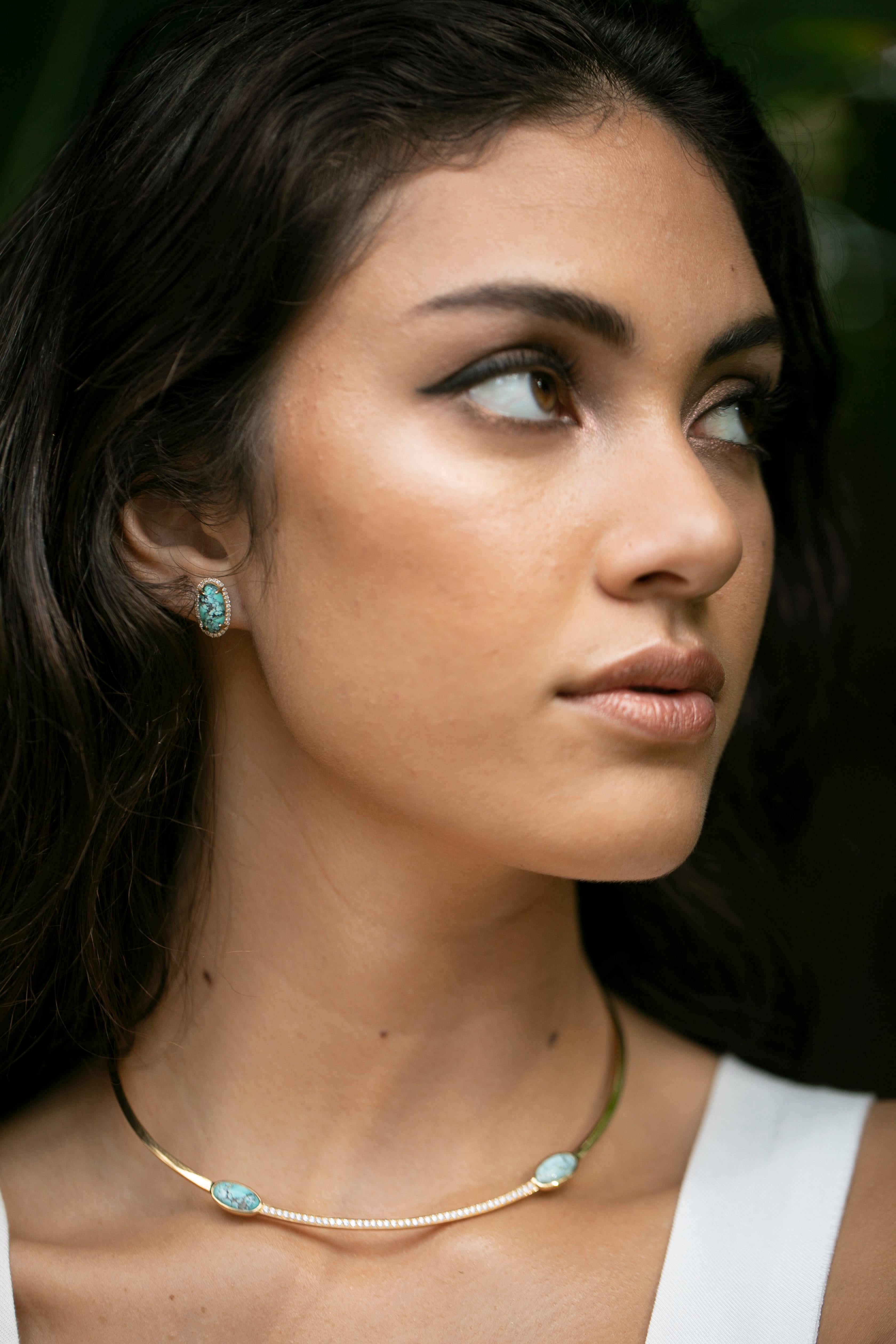 Cabochon natural turquoise studs with a halo of white diamonds with a total carat weight of 0.25cts set in 18k gold.
Made to order in your choice of 18k gold item takes 5-6 weeks to ship. 
Please note turquoise may differ from photos.