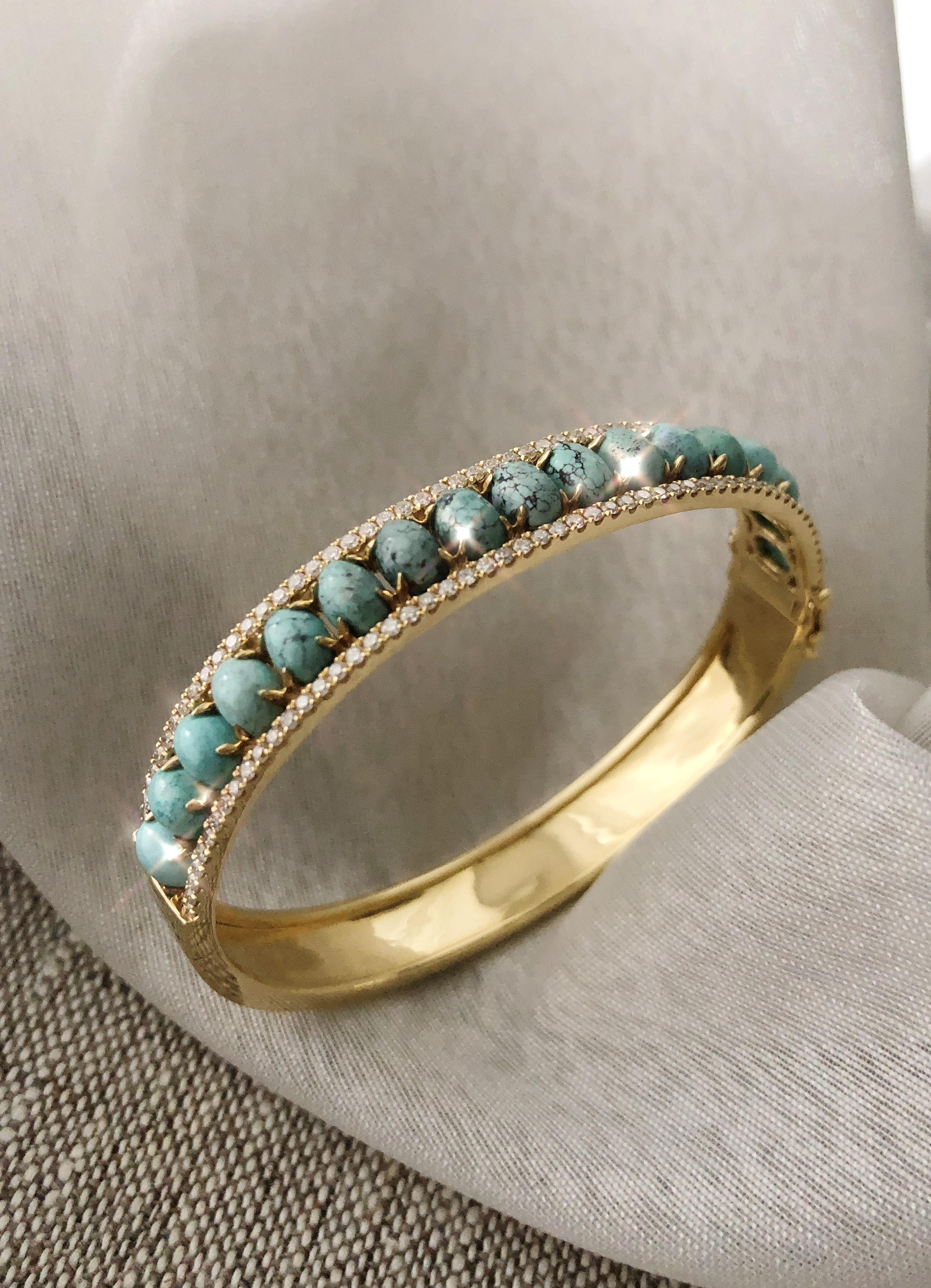 Sleek and Contemporary, wear this bangle from day to night. Set with cabochon natural turquoise and flanked by rows of white diamonds in 18k gold. Diamond weight of 1.11cts in 25.9g gold (size M). Hinged bangle with side clasp and safety clasps.
