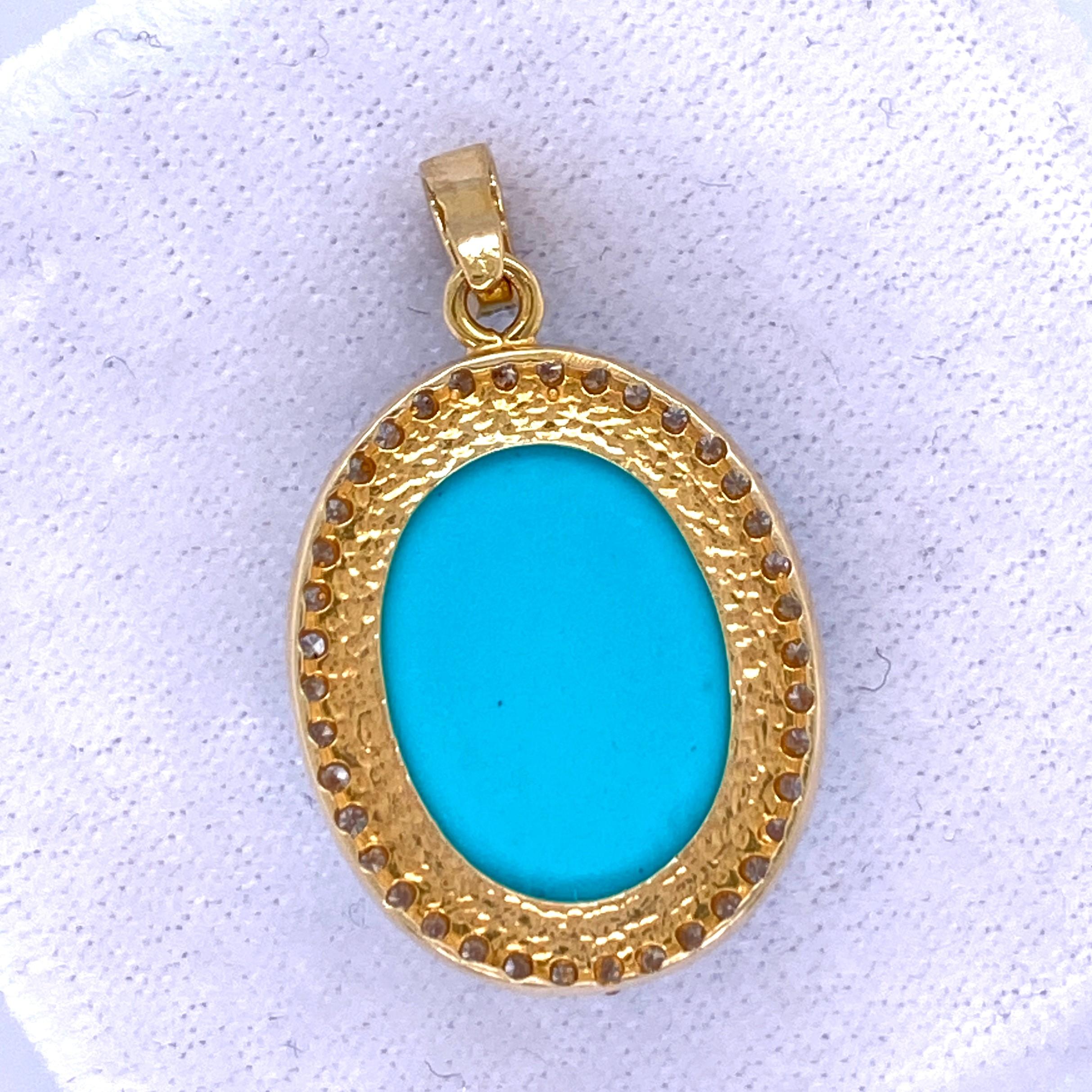 One 14 karat yellow gold (acid tested) pendant, set with one 15.5 x 11.5mm oval turquoise stone surrounded by thirty-seven round brilliant diamonds, approximately 0.33 carat total weight with G/H color and SI clarity.  The bail is set with four