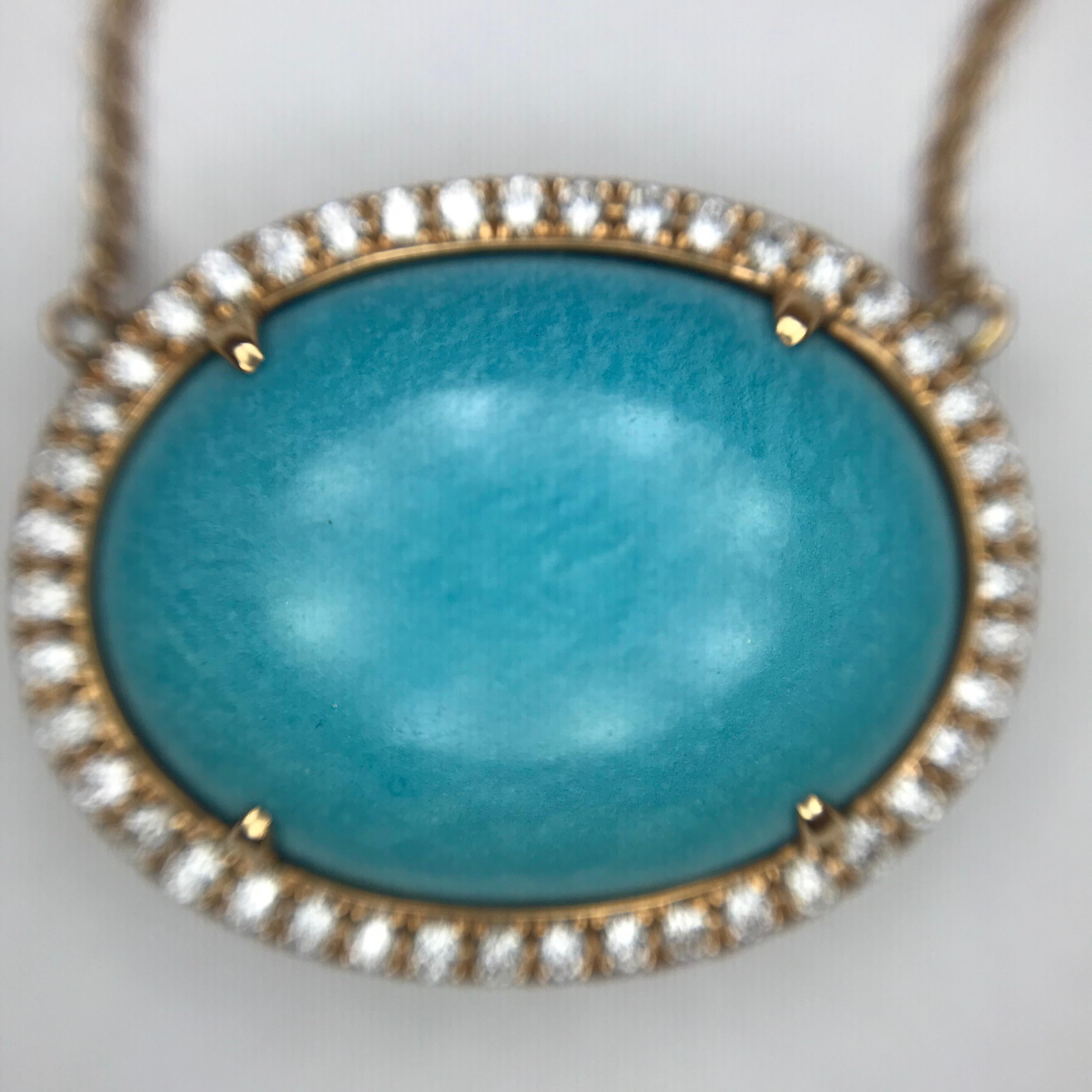 Rose gold adds pleasing warmth to this simple, classic and versatile necklace. It centers an oval turquoise cabochon, bezel-set with accent prongs, surrounded by a diamond halo.

Oval-Shaped Turquoise Cabochon: 12.70cts.
Round Brilliant-Cut