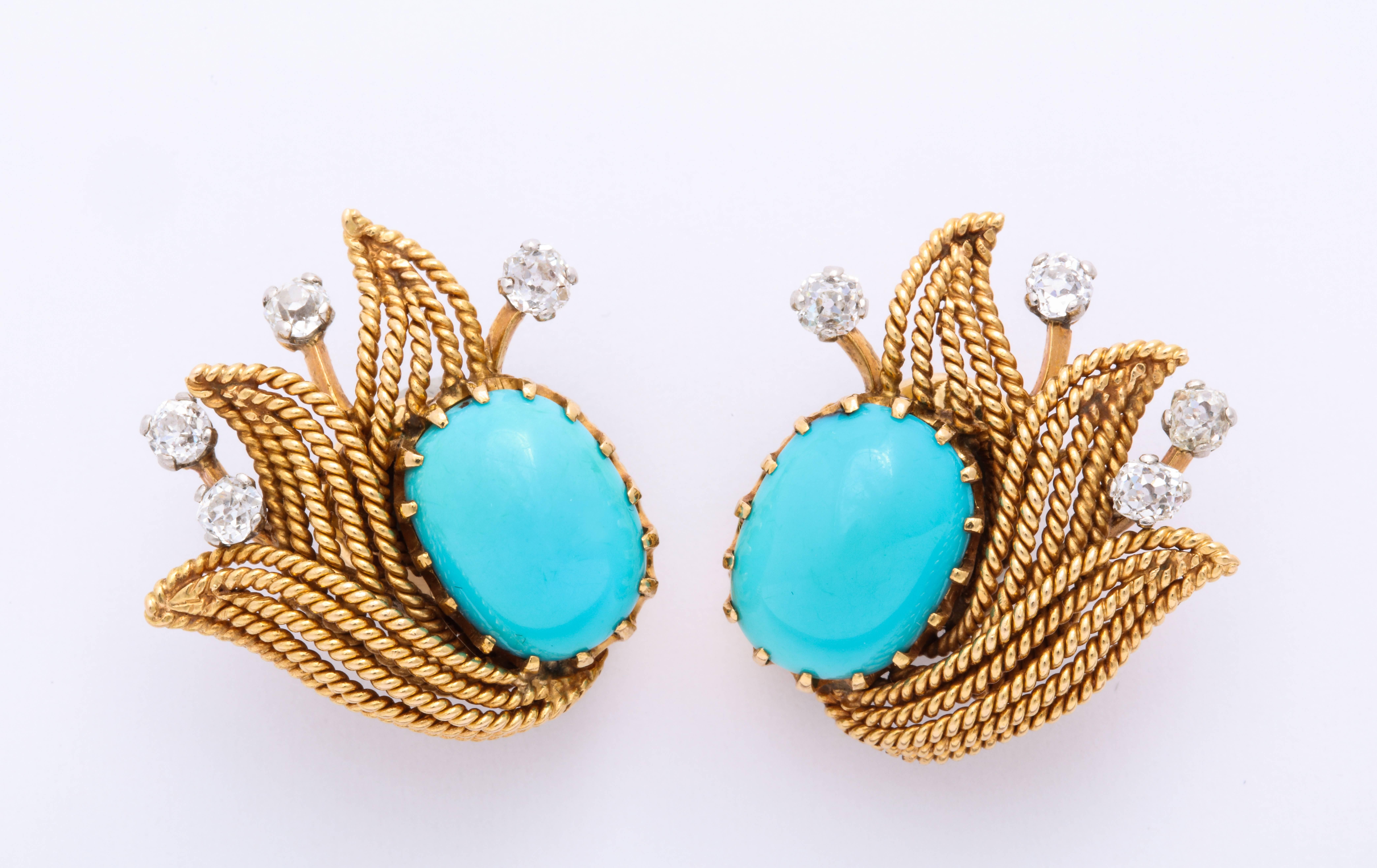 Pair of retro-era earrings featuring turquoise and diamond. The turquoise measures 13.46x9.84mm. There are 8 old cut diamonds with a total estimate weight of 0.96 carats. Set in 18 karat textured yellow gold. Circa 1940s-1950s. 