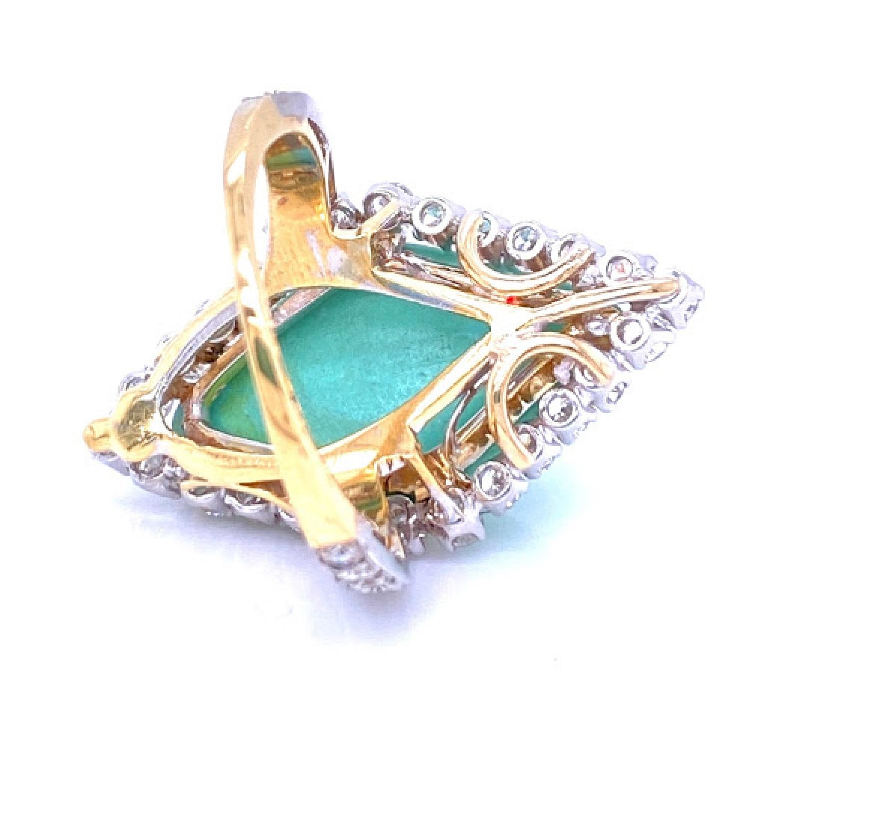 18 karat yellow gold and platinum (not stamped) ring with turquoise center stone measuring 24 mm by 12 mm. There are 38 round brilliant diamonds along the shank of the ring as well as the halo. The diamonds weigh approximately 1.50 carat total