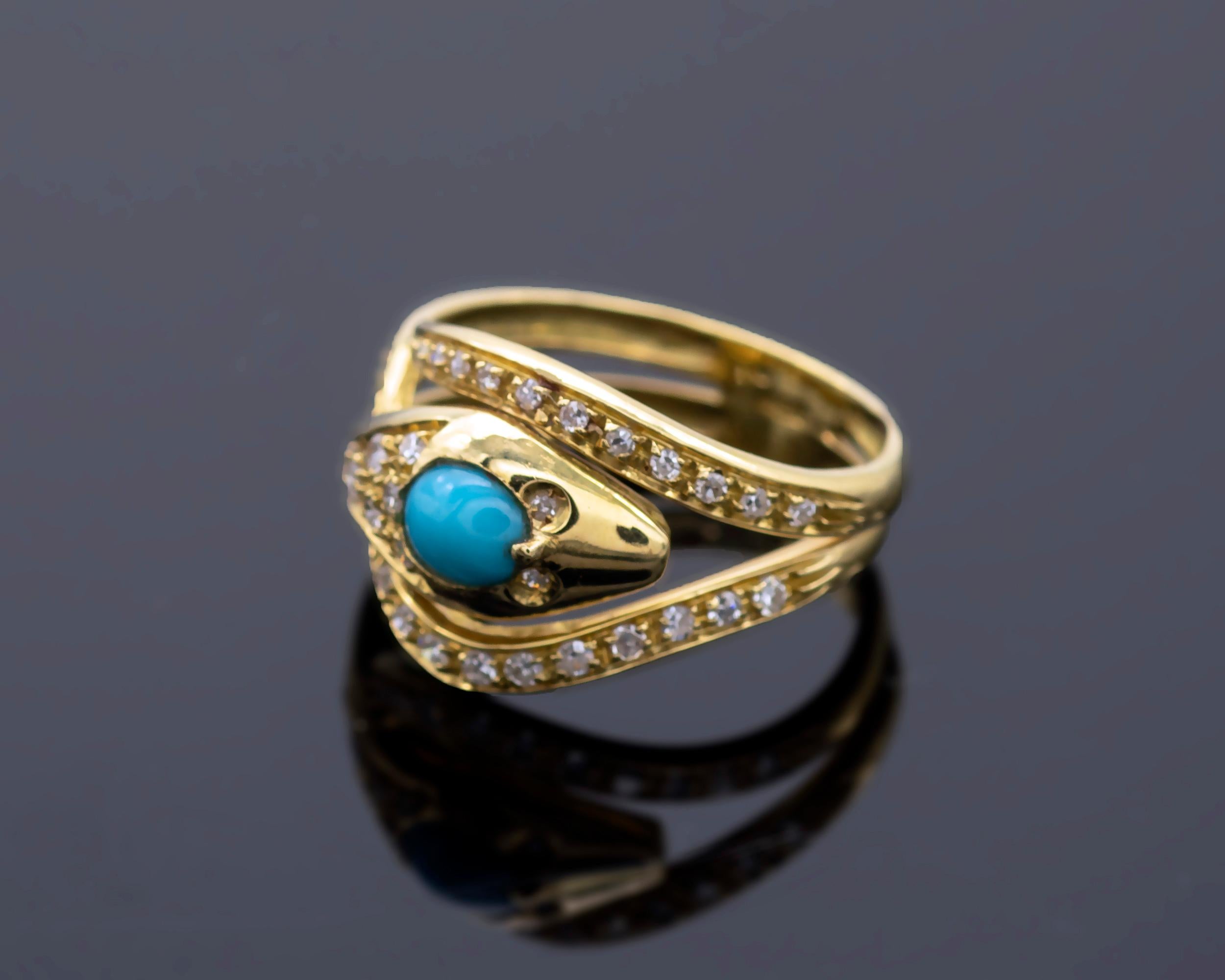 A 18kt yellow gold snake ring wrapping around the finger. A Persian turquoise with vibrant colour on its head, the eyes and body are set with diamonds.
