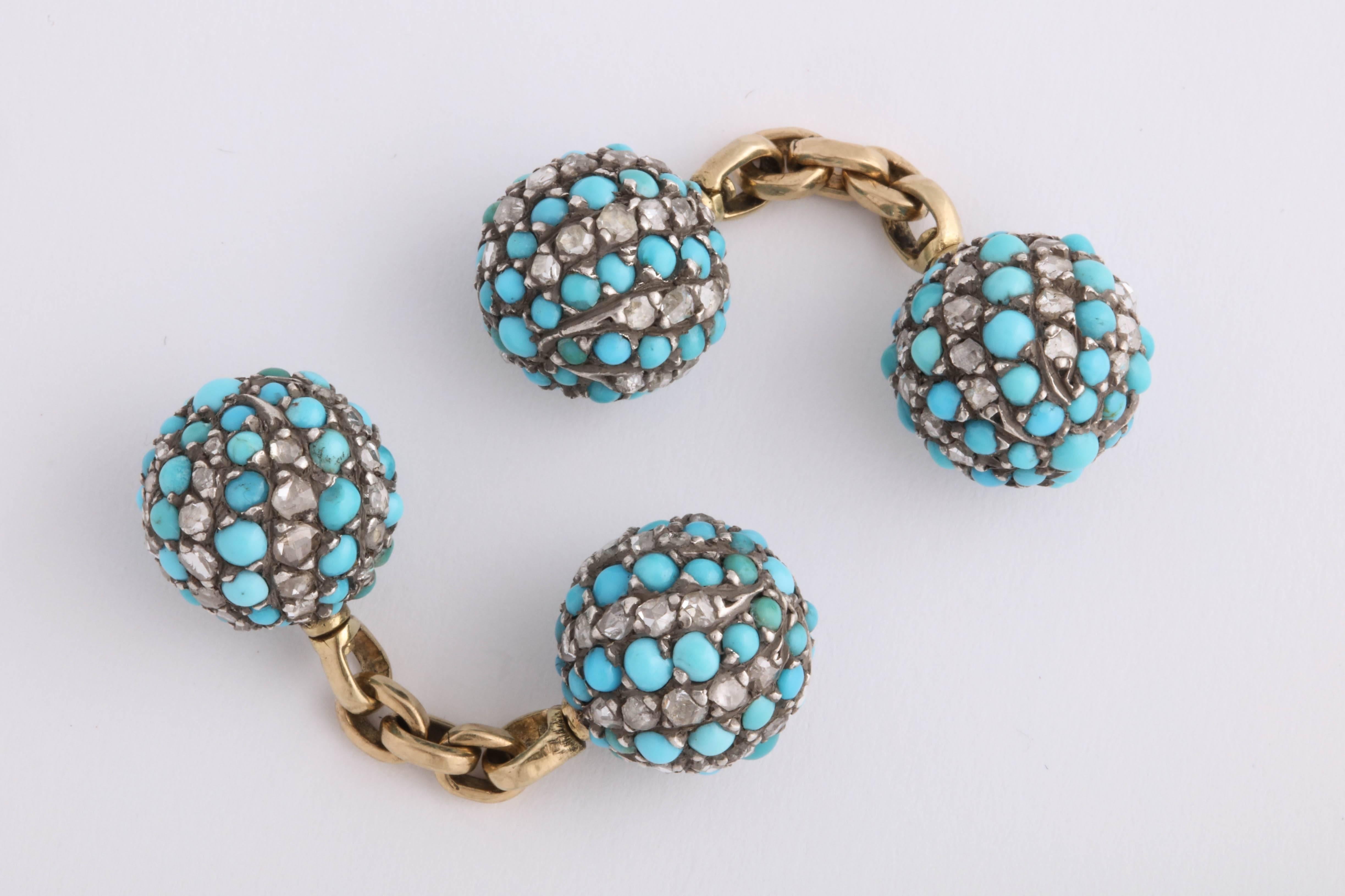 Very rare ball cufflinks with a yellow gold chain in between. Each ball is set with turquoise and rose cut diamonds in silver in a swirling design. Victorian, c. 1880s. 