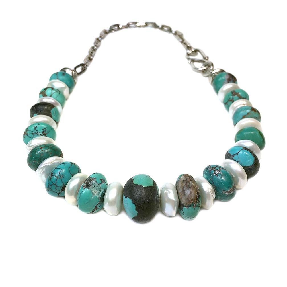 Nouveau Boutique created this turquoise and freshwater pearl necklace with unusual leather-polished matt finished turquoise (up to 14 x 20 mm) and large freshwater button shaped pearls. A 6.5 inch long heavy block sterling silver chain with a large
