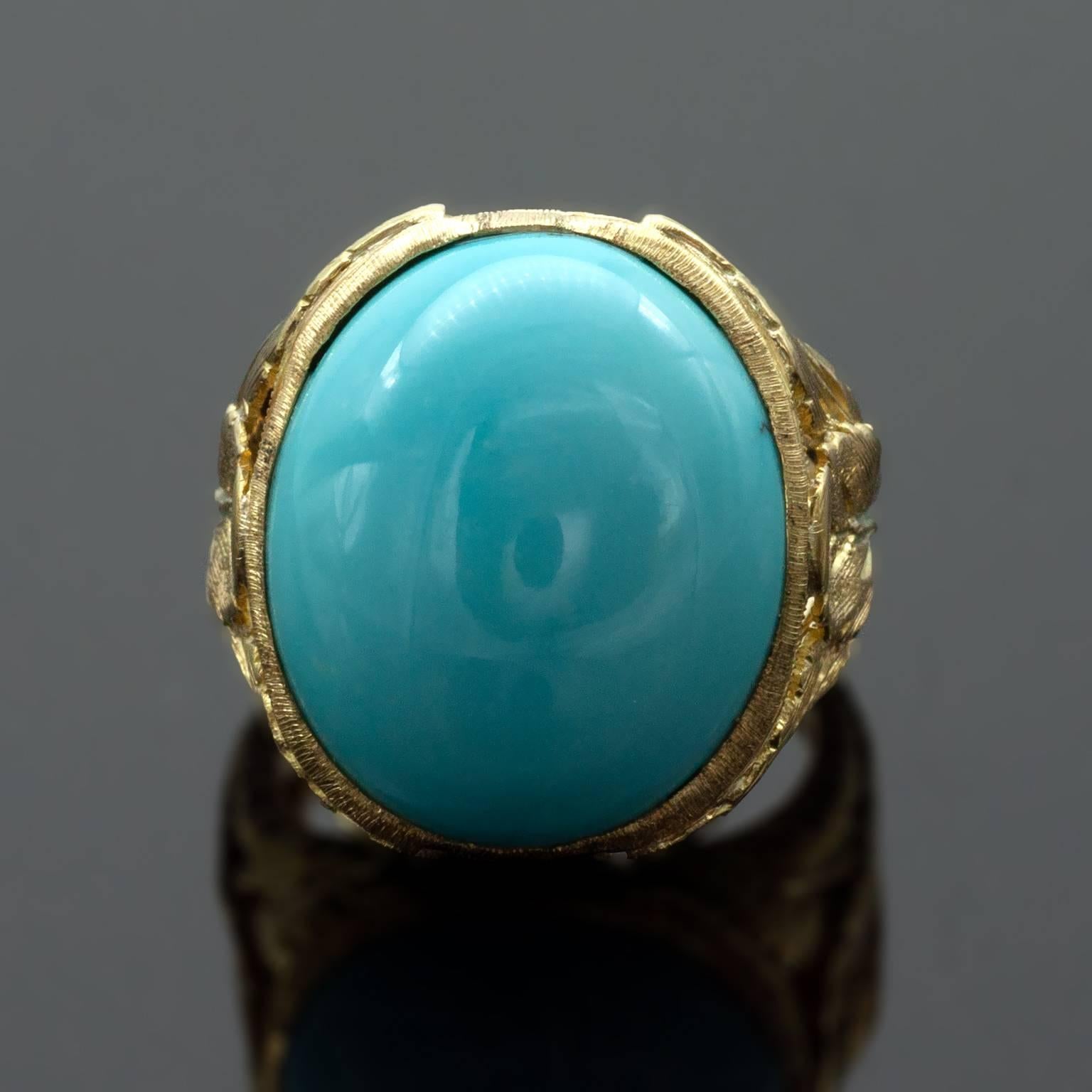 Remarkable  engraved cocktail ring in the florentine style (the very style that has been made famous by Buccellati). Six chiseled leaves holds a soft blue natural Persian turquoise  weighing 19.57 carat. The ring is very well made 