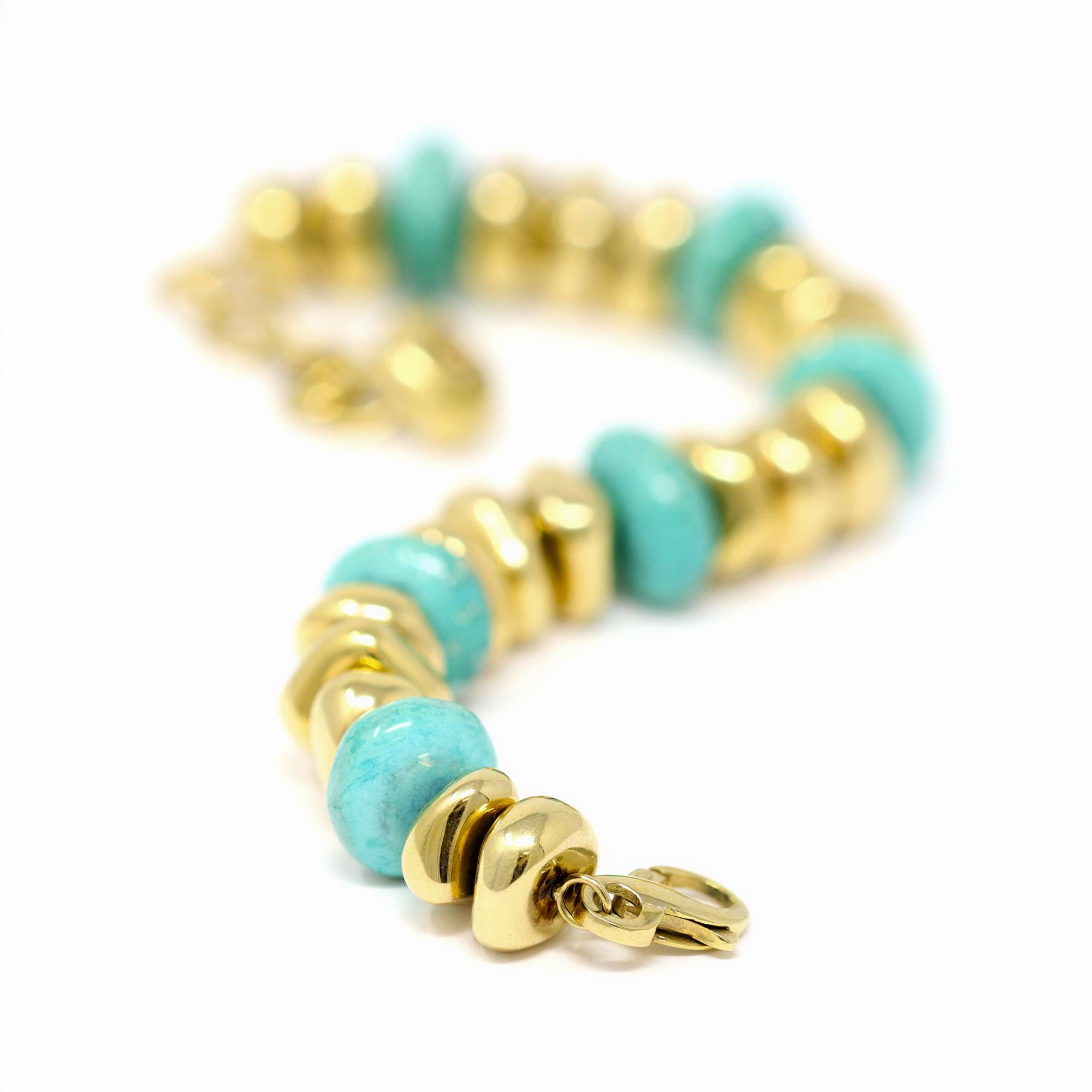 A fun bracelet originated in Italy presenting turquoise and gold beads all pebble shape. The bracelet is made in 18 karat yellow gold and sits very comfortably on the wrist. It weights 36.5 grams and is 8
