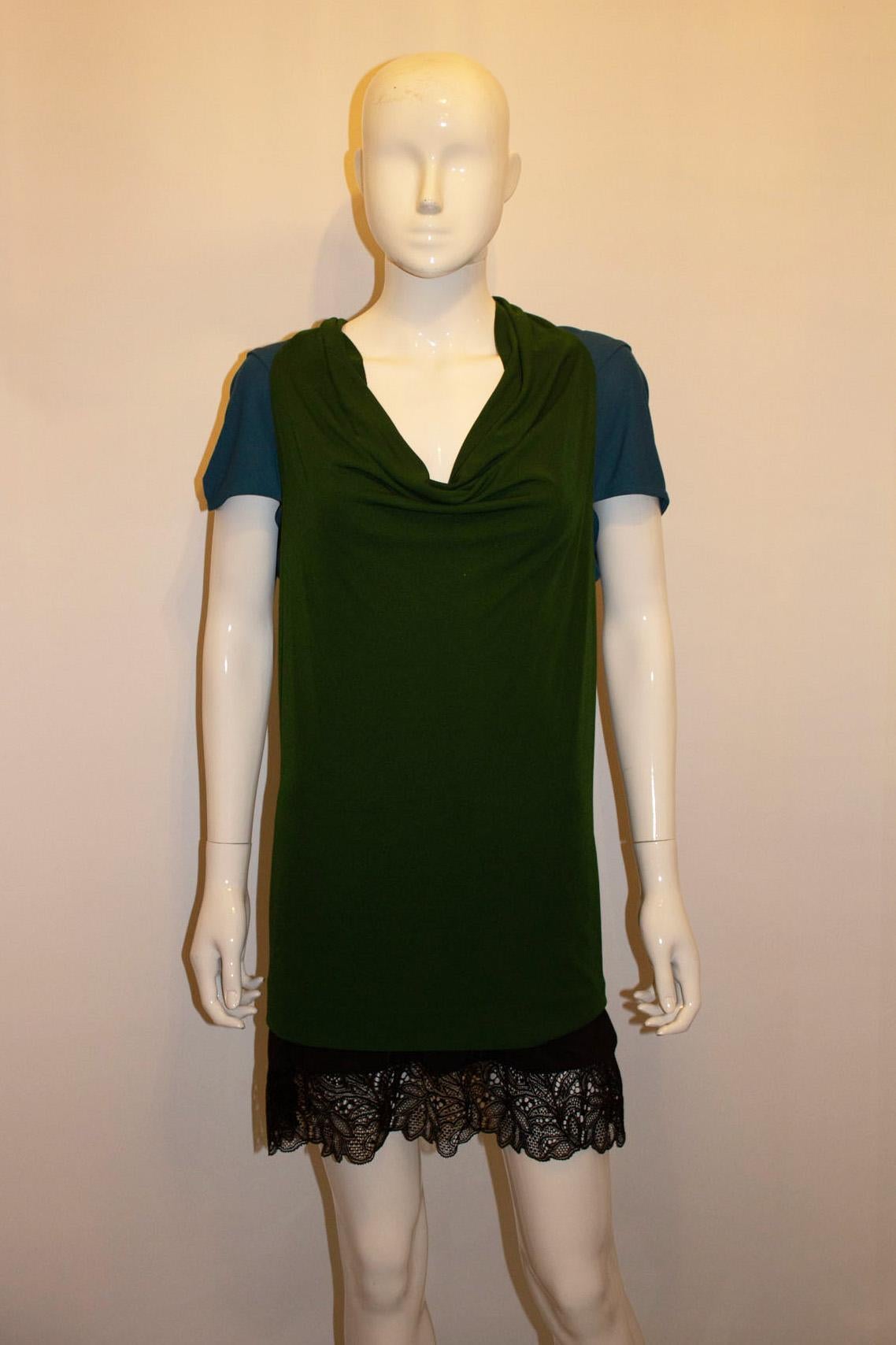 A colourful and easy to wear top by Roland Mouret. 
In a great mix of turquoise and emerald green, the top has cap sleaves.  Made of viscose in a great weight , and so hangs beautifully. 
Made in Portugal . UK size 14 , US size 10 EU size 42. 