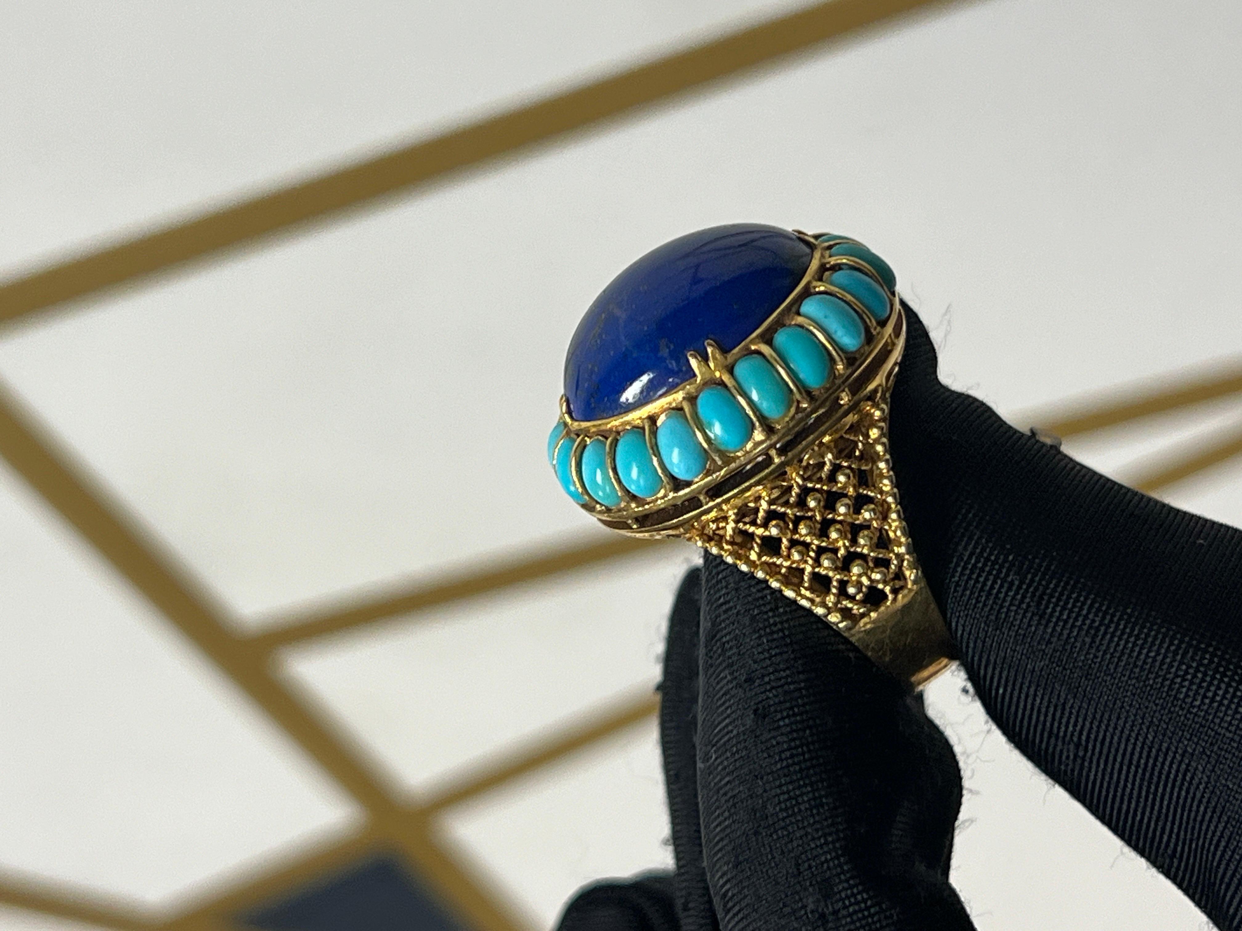 Turquoise and Lapis Lazuli Ring 

A yellow gold ring set with an oval lapis lazuli accented by turquoise. 

Ring Size: 7
Resizable free of charge
Metal Type: 14-karat gold