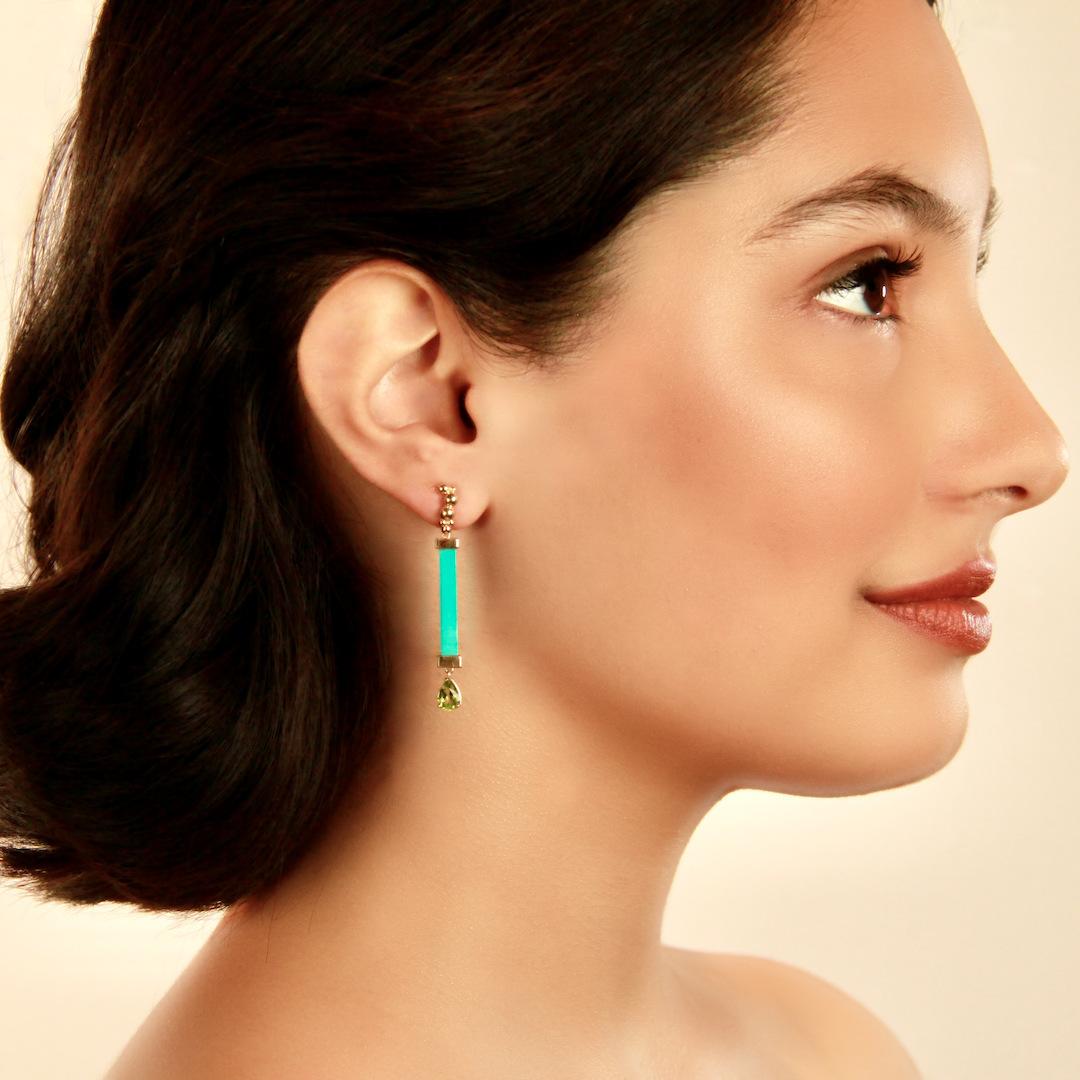 We make these colorful earrings in 14k yellow gold set with rectangular turquoise batons and peridot teardrops. The the total length of the earrings is 48mm (1 7/8