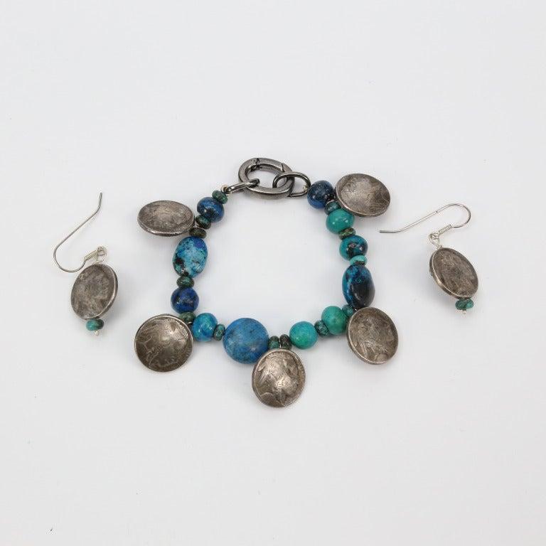 Awesome Turquoise and Silver Necklace, assorted Turquoise shapes and sizes inter-spaced with Silver Indian Head discs. Hand crafted; approx. 17 inches long. Companion Bracelet and Earrings are available. See item #AU13092851541. Vintage beads and