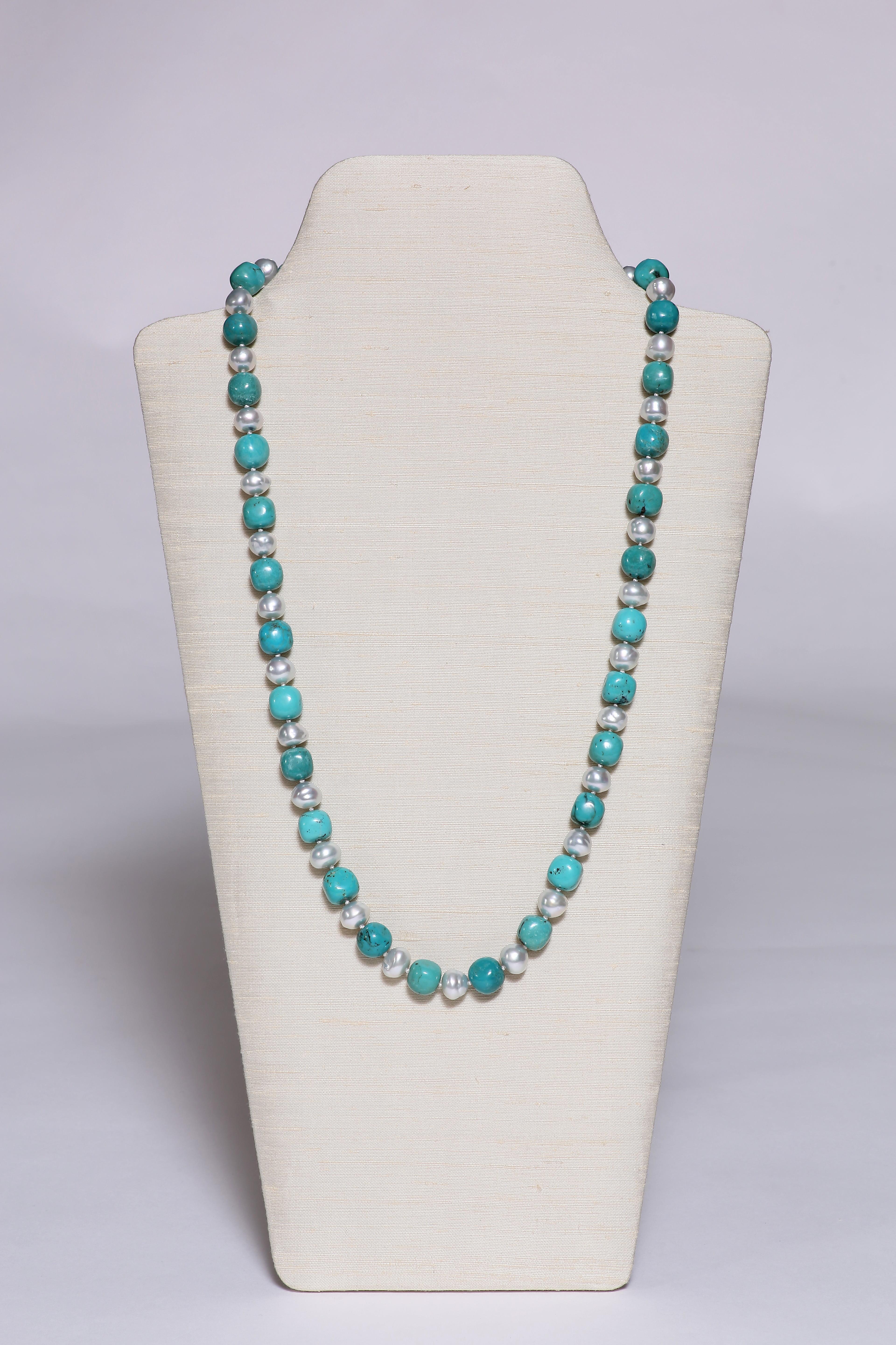 A classical necklace of fine round-shaped turquoise beads spaced by South Sea pearls, forming a 28 3/4