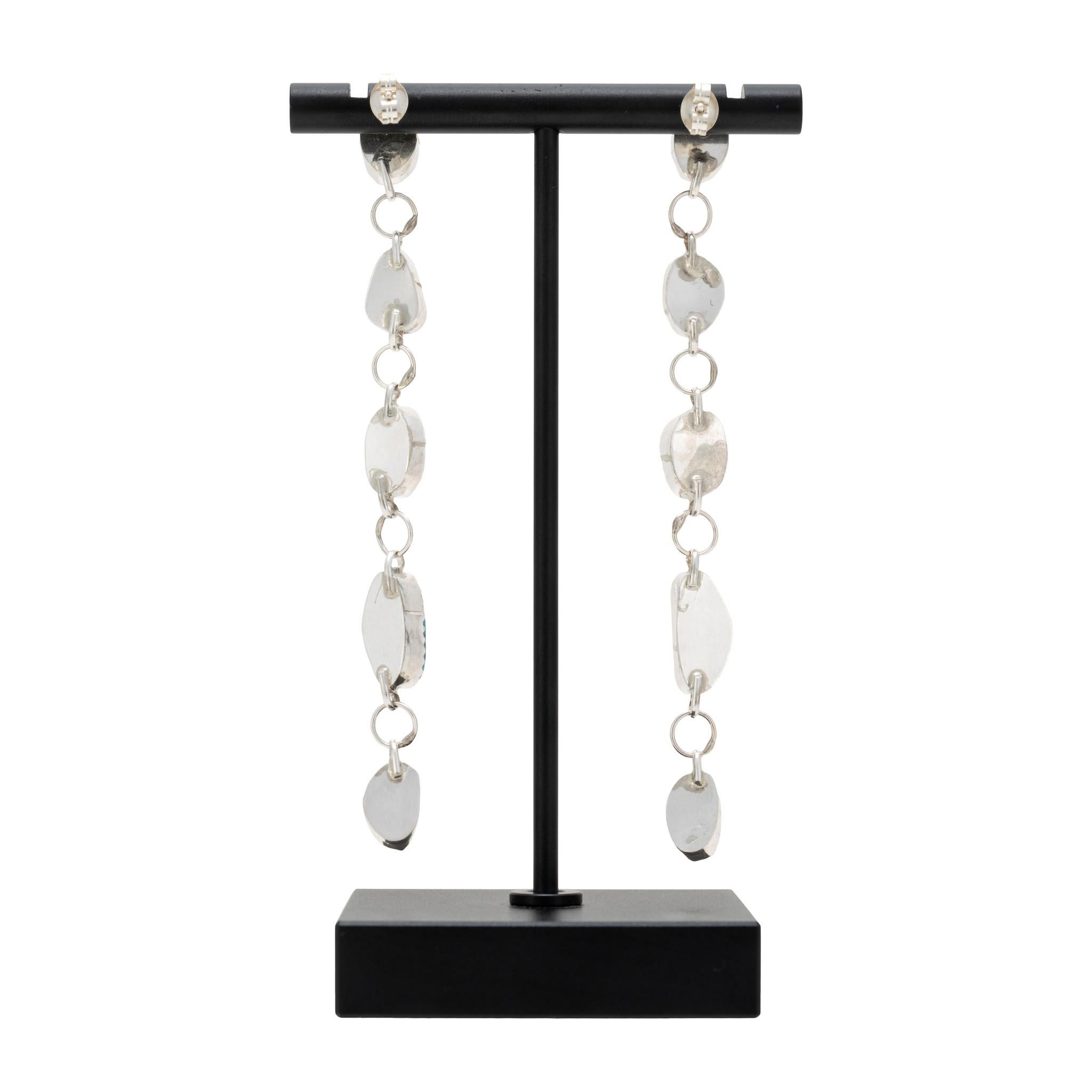 Coppia di orecchini pendenti in argento sterling e turchese della Bella Addormentata. Gli orecchini sono caratterizzati da una splendida e professionale montatura in argento sterling con un design a maglie pendenti. Un totale di dieci cabochon di