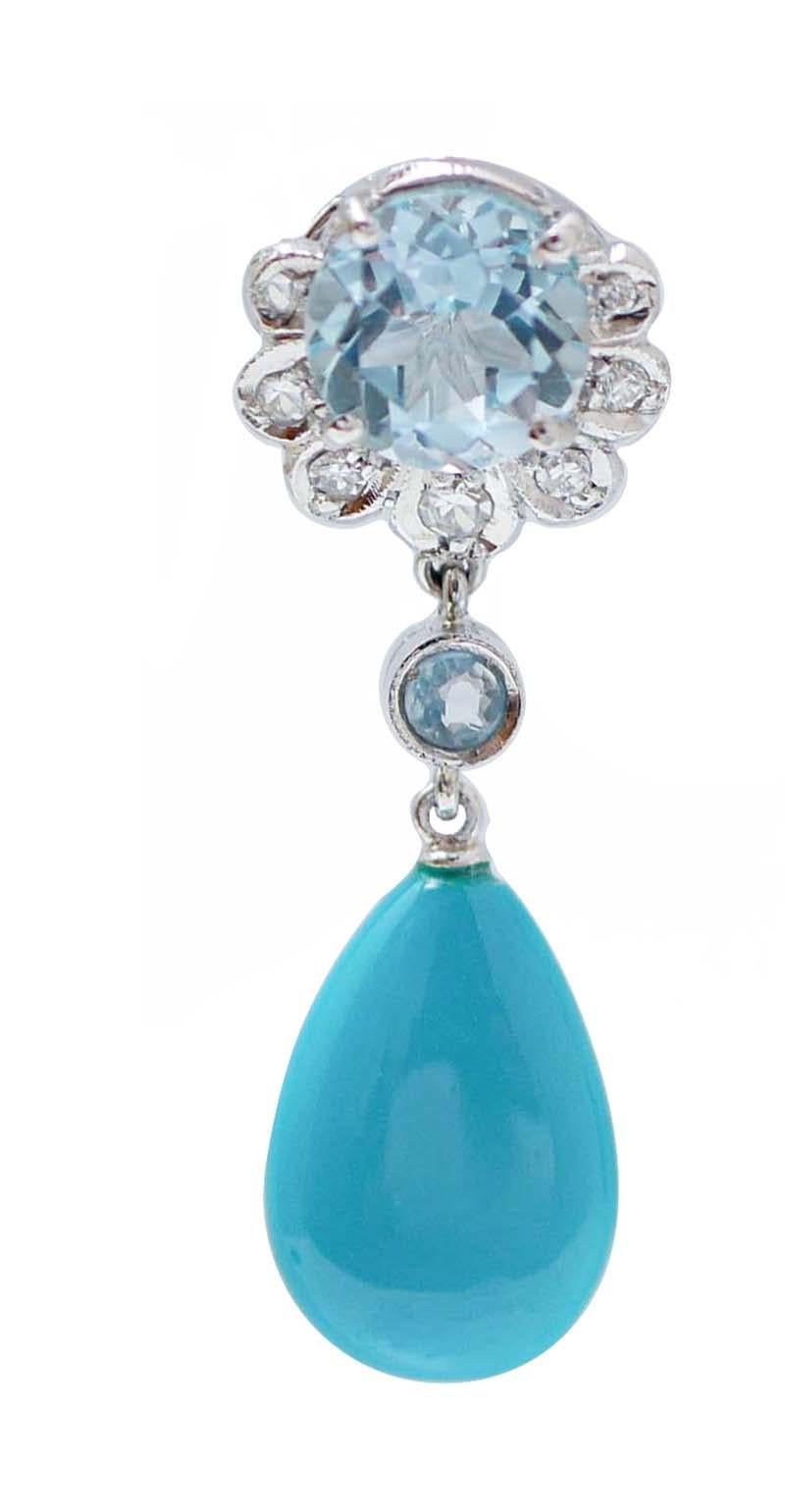 Amazing earrings in platinum structure mounted with a topaz surrounded by diamonds in the upper part; in the middle, a little topaz and, as pendant, a drop turquoise.
These earrings were totally handmade by Italian master goldsmiths and they are in