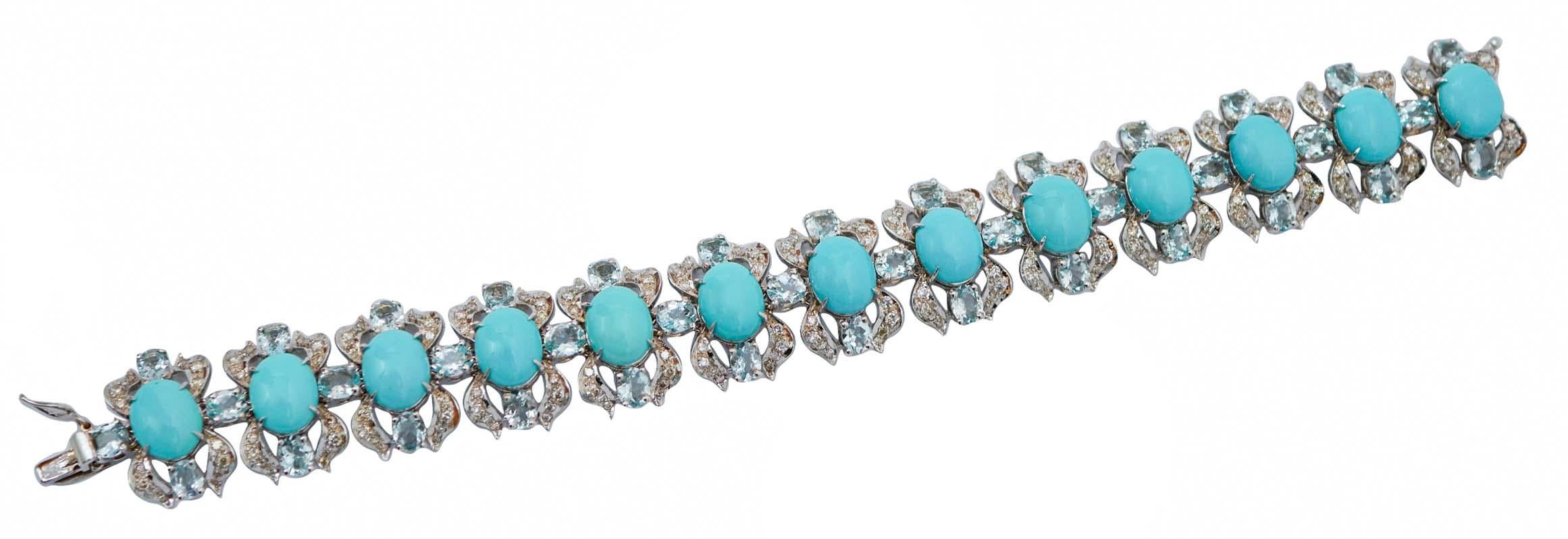 Fantastic bracelet in 14 kt white gold structure composed by 13 sections mounted with an oval turquoise surrounded by diamonds and two aquamarine. The sections are linked between of them by an aquamarine.
This bracelet was totally handmade by