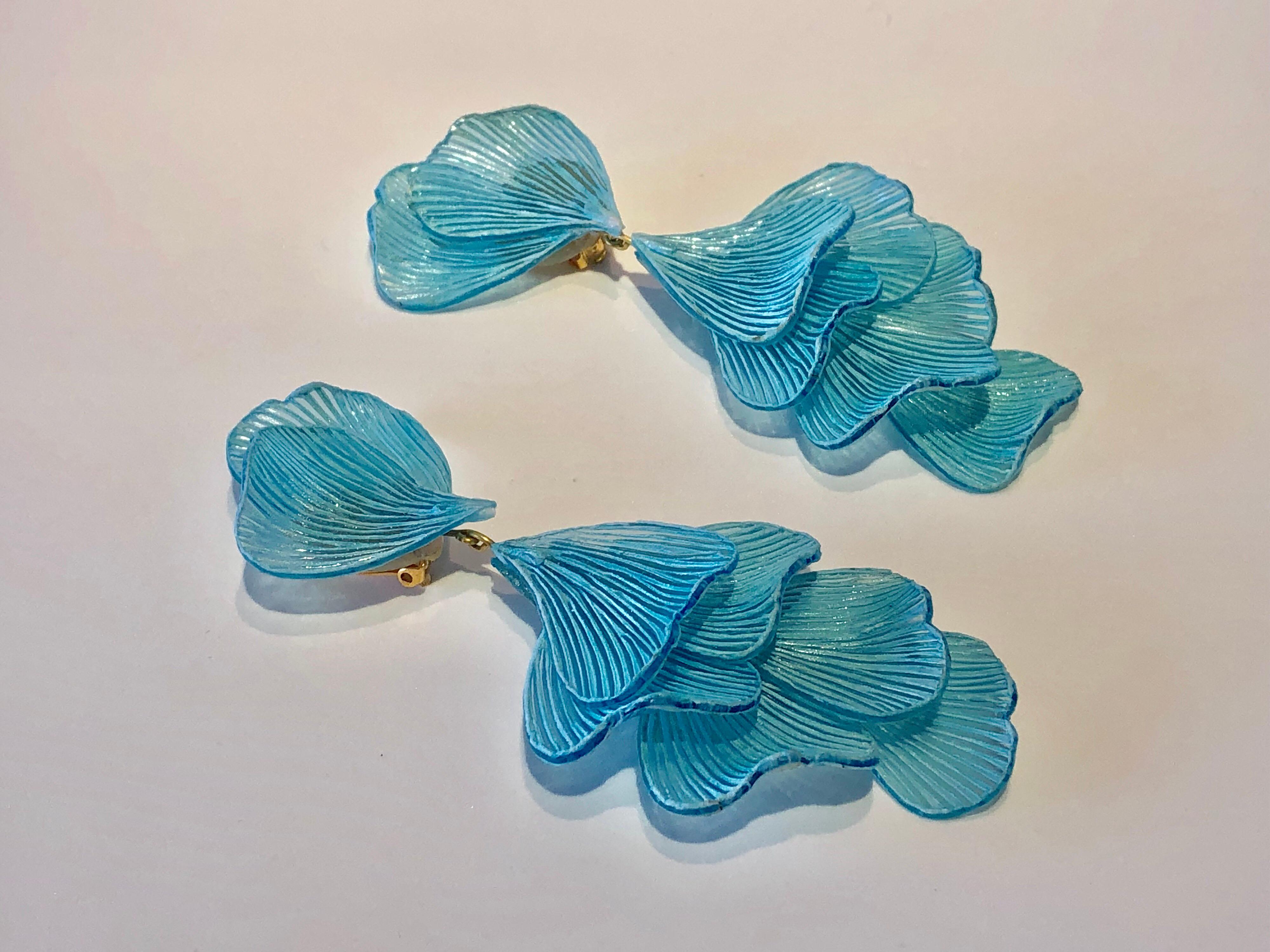 Light and easy to wear, these handmade artisanal clip-on earrings were made in Paris by Cilea. The lightweight clip-on earrings feature molded wave segments of enameline (enamel and resin composite) in turquoise, almost resembling whimsical fish