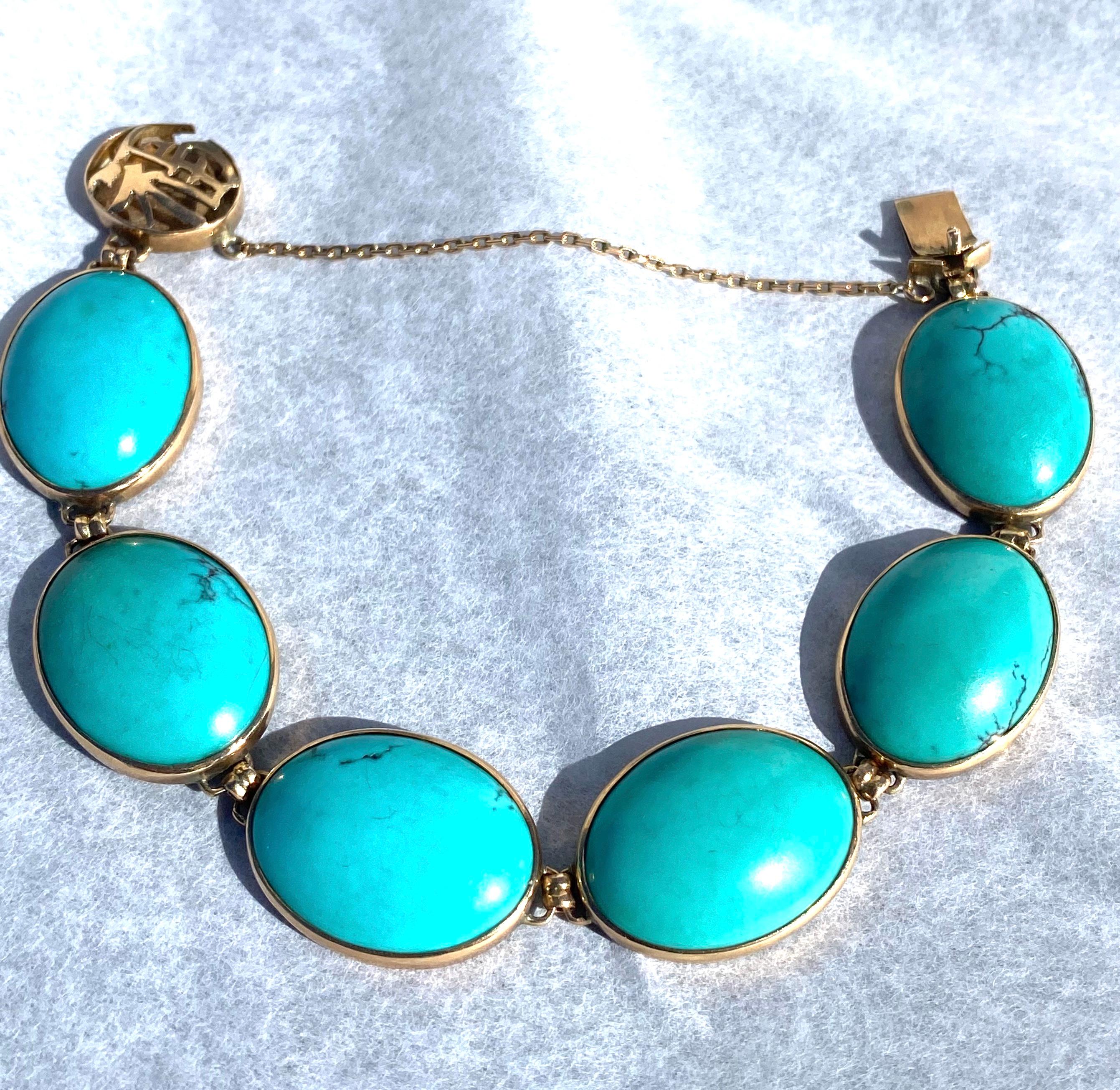 Beautiful Turquoise Link Gold Bracelet set in 14 Karat Yellow Gold.
A gold Asian accented clasp measures 14.30 mm, a safety clasp adorned, while six large oval-shaped Persian-colored turquoise gemstones are set in this lovely bracelet.
The length is