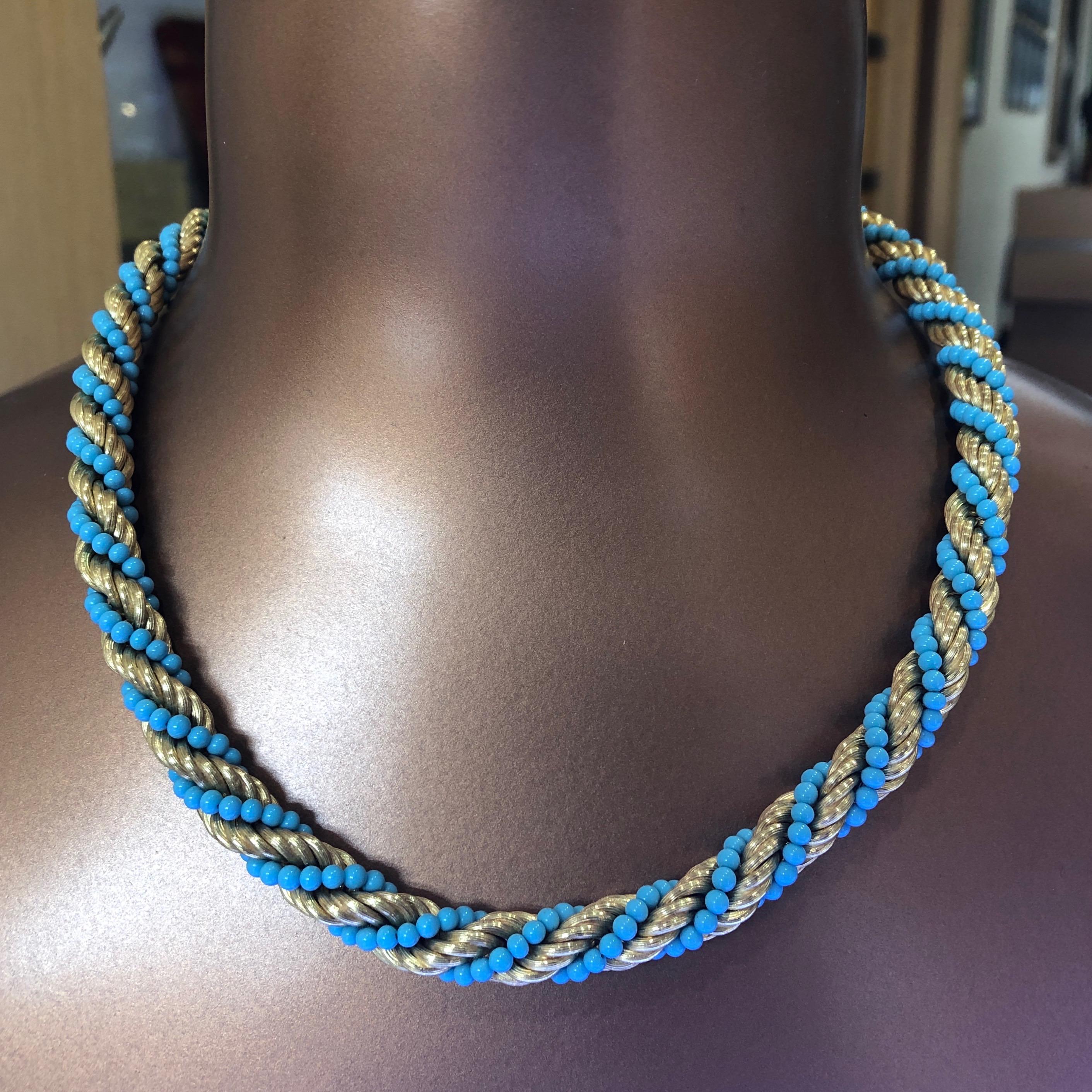This retro estate necklace features sleeping beauty Turquoise round beads elegantly woven and twisted in solid 18 karat yellow gold ribbed chain. The necklace measures 19