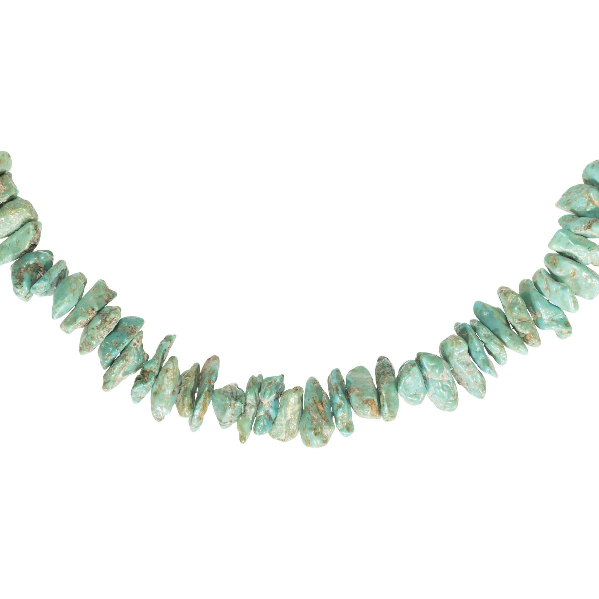Damele turquoise beaded necklace on sterling chain with hoop closure. Stones are all located at the bottom center of necklace with petite sterling beads travelling up either side of chain. Turquoise stones are a bright green color cut in a natural