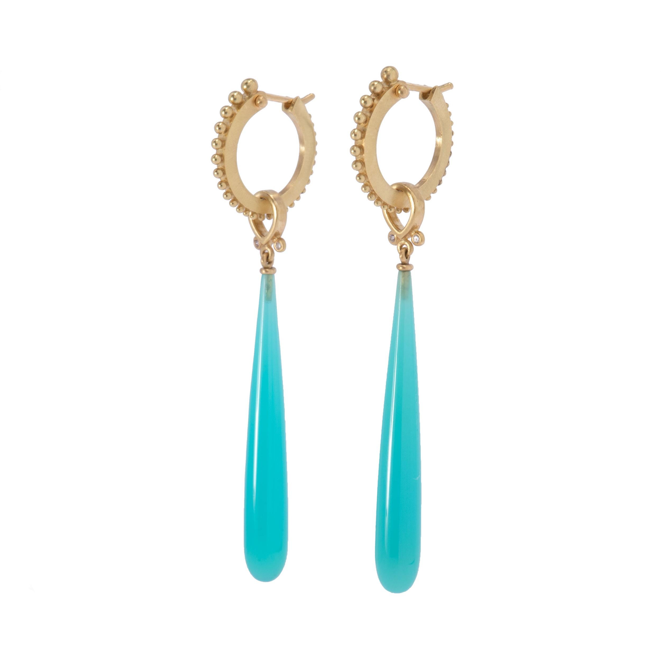 Long wands of Turquoise Blue Laguna Agate hang from 18 karat gold anjou tops set with .04ctw diamonds. Juicy, slightly milky color in turquoise blue wands swing from looped anjou tops set with 2 round white diamonds. Hung from large narrow beaded