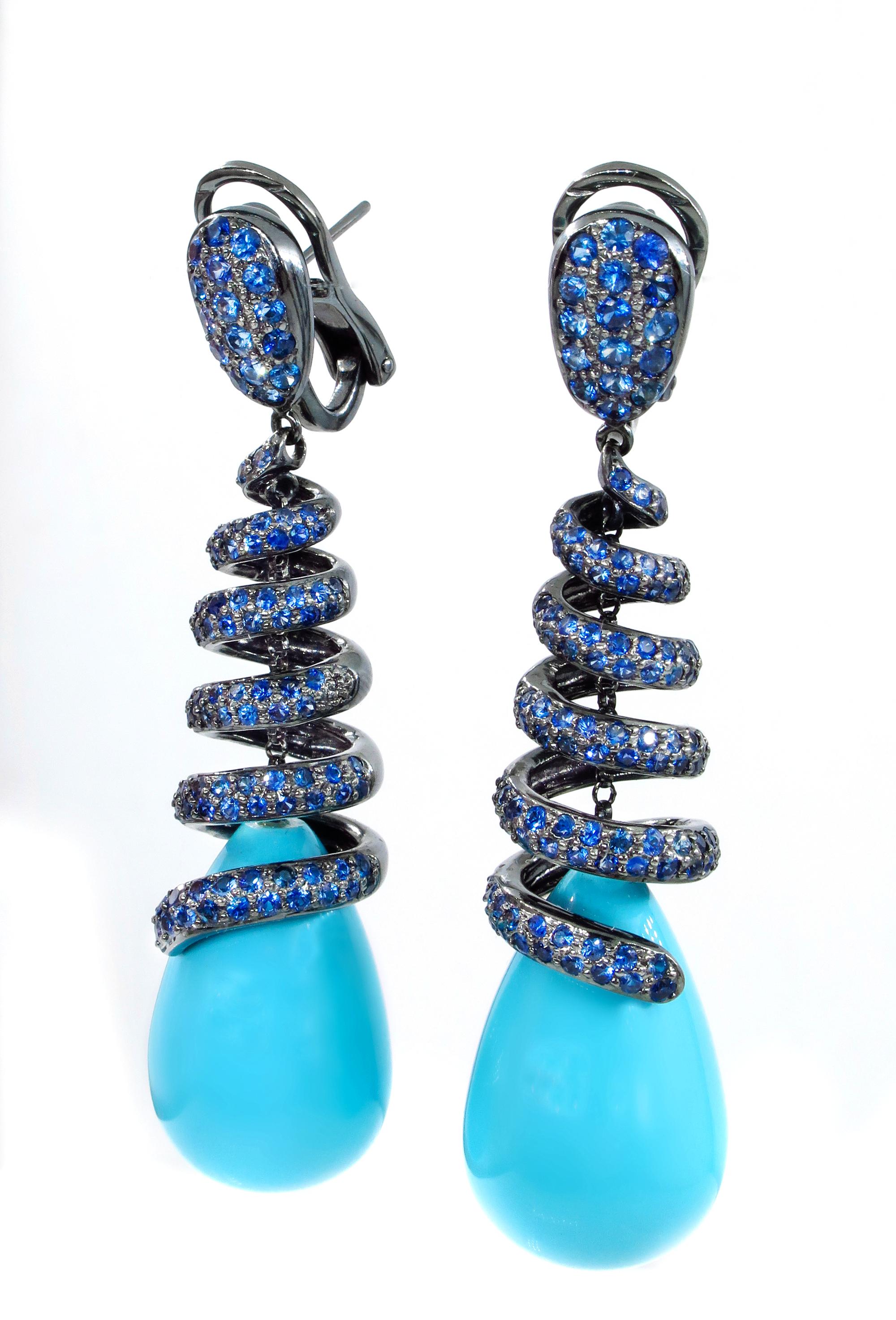 These earrings are spectacular! This extraordinary perfectly matched Baby Blue Turquoise Teardrop mounted into magnificent Swirls of Blue Sapphires drop Earrings.
Fabulous workmanship on both front and back this set looks great from any angle!
The