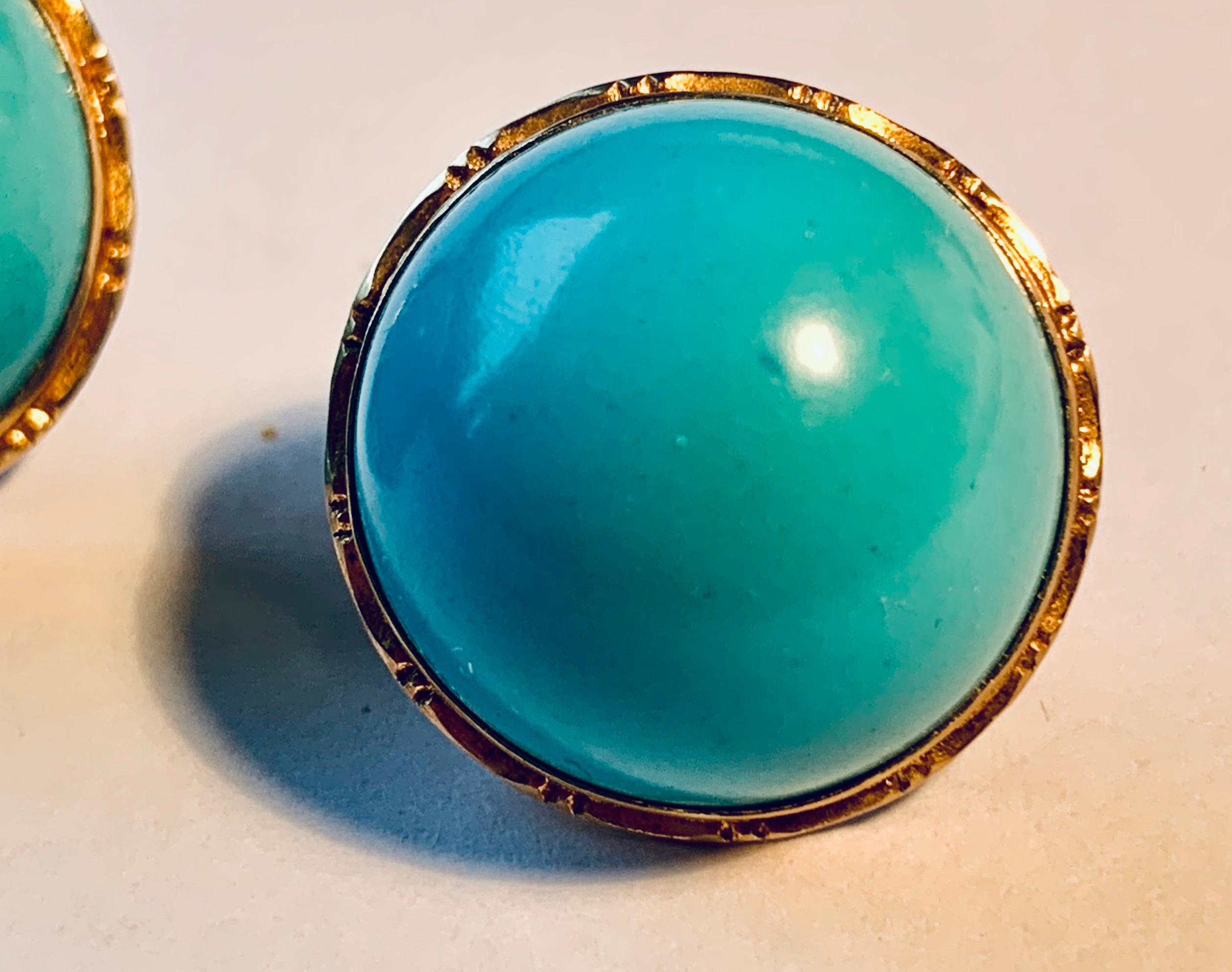 Pair of round 14k yellow gold engraved earrings set with cabochon turquoise stones.  The backs are clips and posts.  The posts can be removed for non pierced wearers.  The are marked 14k and 585.
