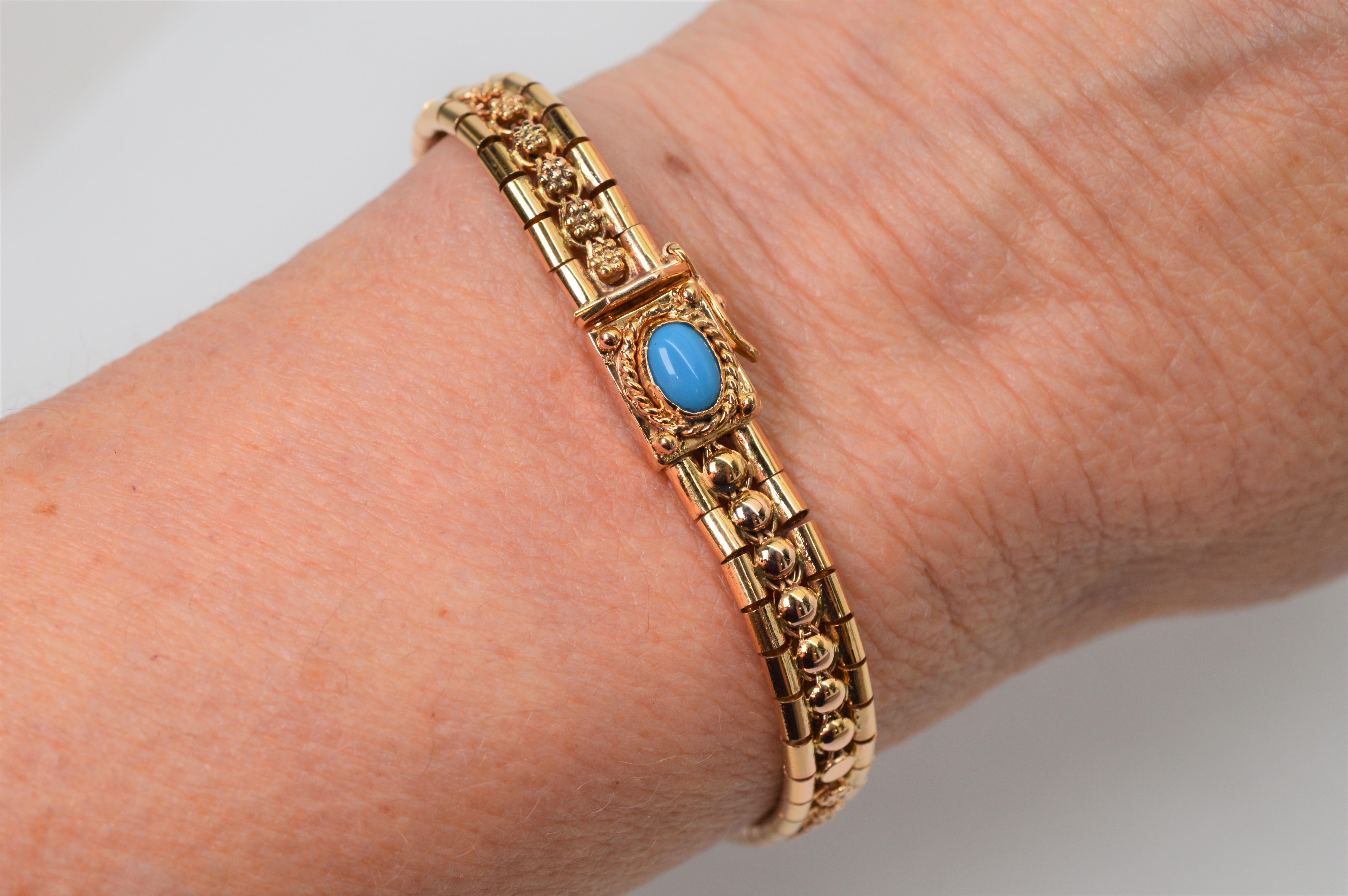 Italian made in eighteen karat 18K fine yellow gold, this perfectly understated bracelet showcases a vivid blue turquoise cabochon that is bezel set and framed with a gold rope on it's buckle detail. 
The elegant bracelet measures 7.5 inches in