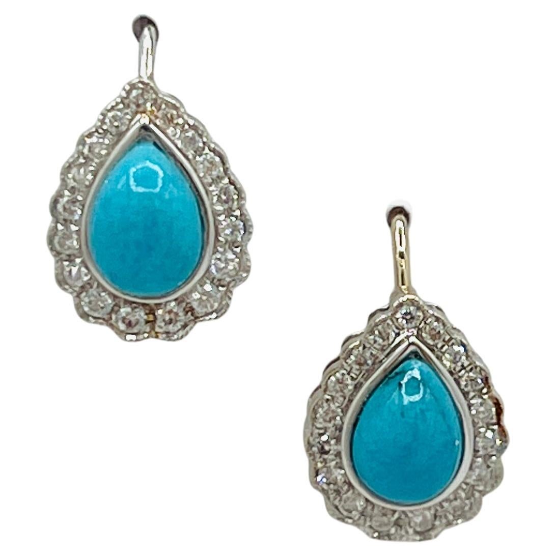Orecchini con pera cabochon di turchese e diamanti bianchi in oro bianco 18 carati