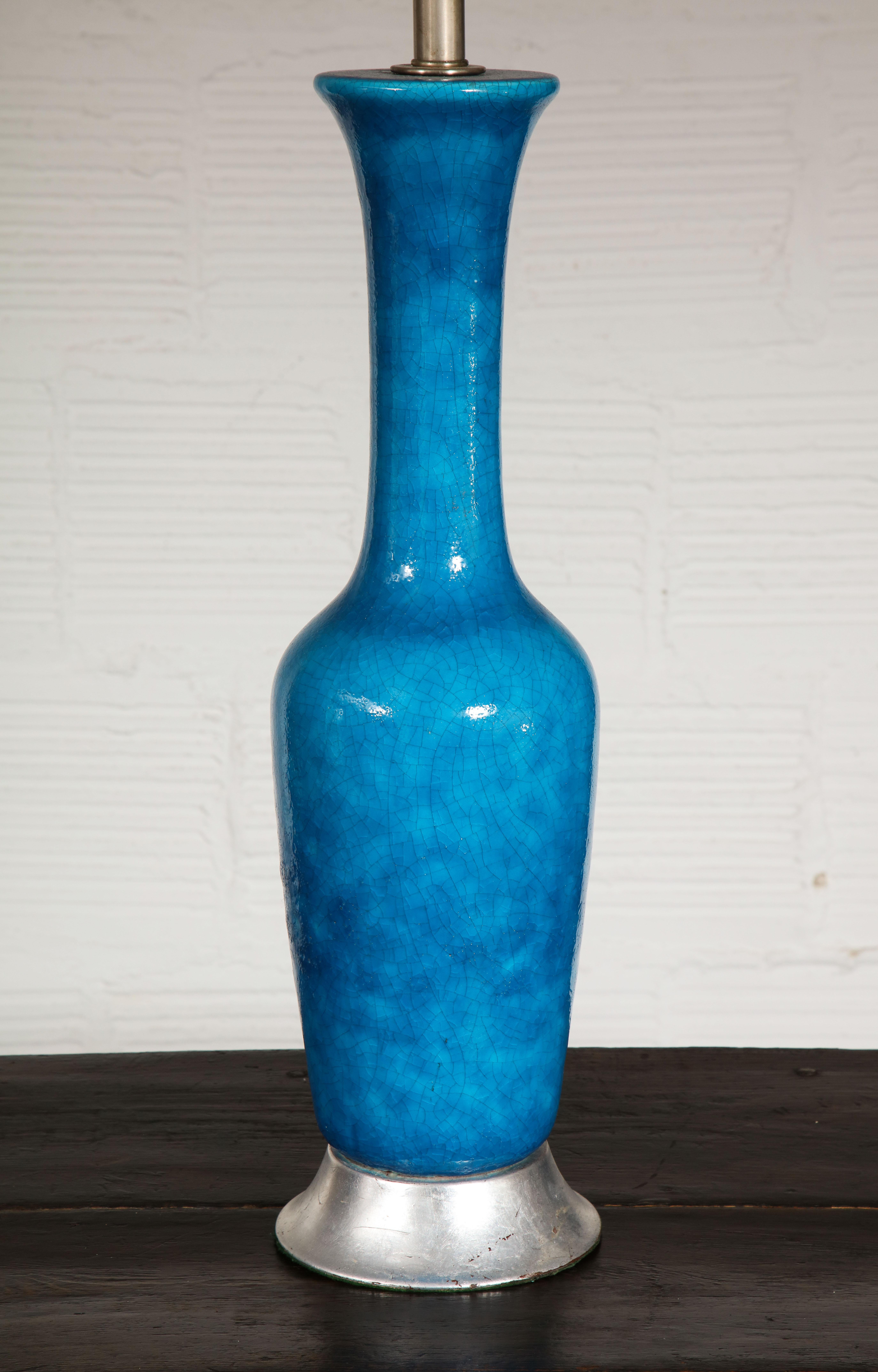 With craquelure finish, exaggerated long neck and silvered wood base. Height to top of vase is 24
