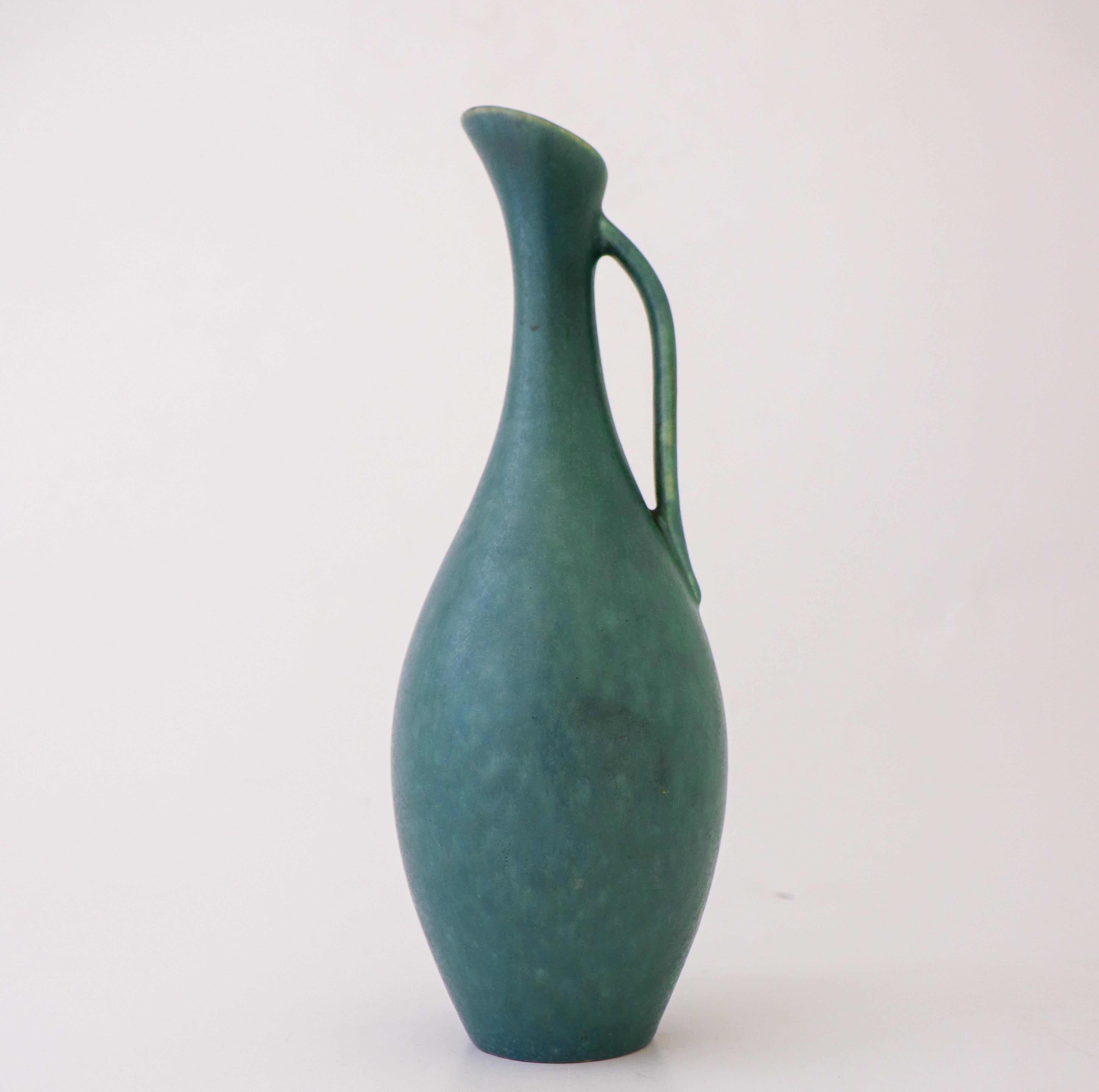 A turquoise ceramic vase designed by Gunnar Nylund at Rörstrand. It is 26.5 cm (10.4