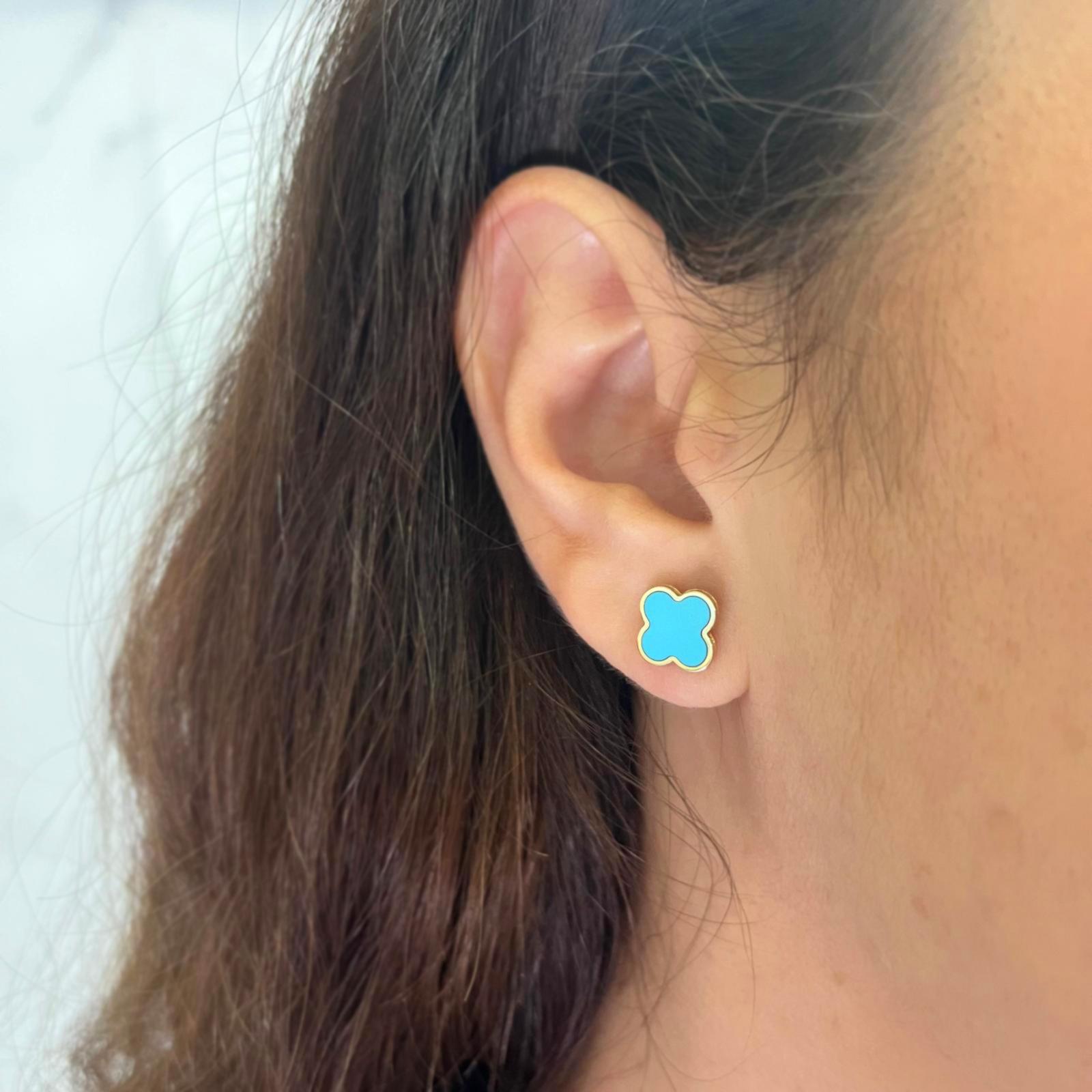 14 karat yellow gold clover stud earrings featuring turquoise inlay. Pierced post with friction back. Finished weight is 1.5 grams.
