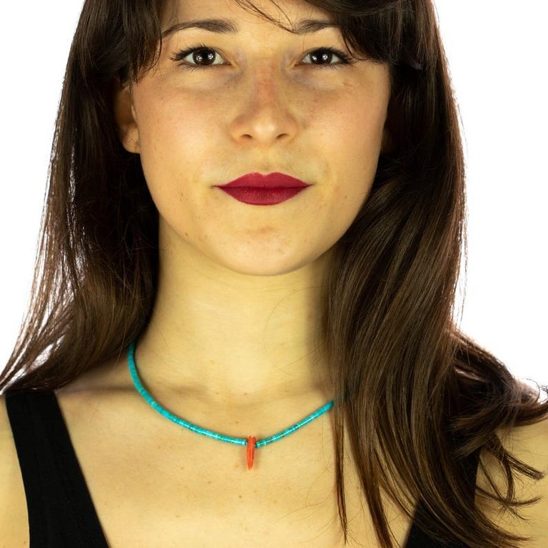 A strand of natural turquoise embellished by a central pendant in red coral. An elegant and light weighted necklace with a unique design full of magic. Immerse yourself in the beauty of this uniquely designed jewel with natural stones full of life