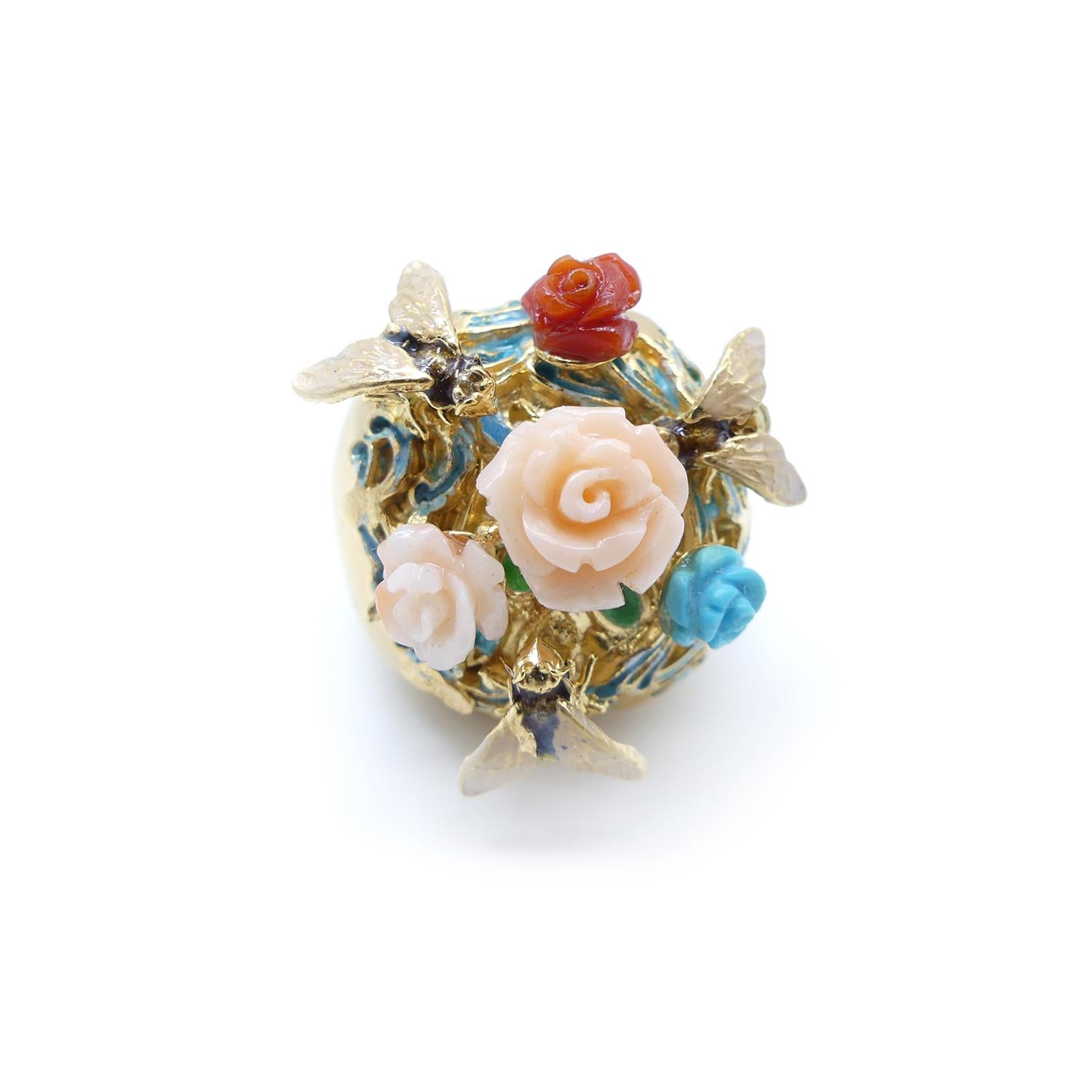 Gold plated ring with coral angel skin, blue turquoise and red coral carved as a roses of different sizes like a garden enameled with bees.

This precious ring belongs to the 
