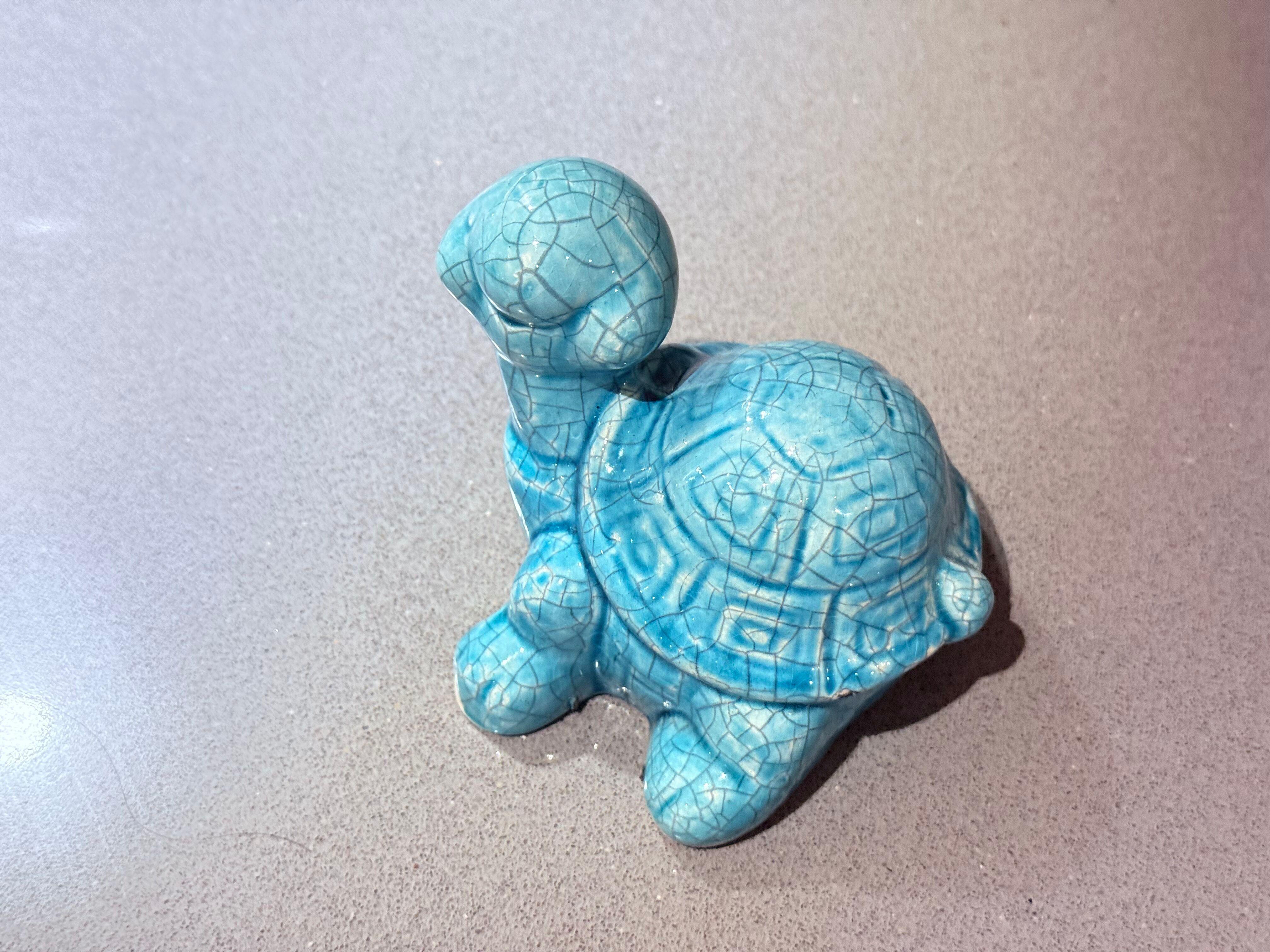 Turquoise Crackle Glazed Ceramic Turtle Figurine, Handmade Pottery Decor
This charming turquoise crackle-glazed turtle figurine captures the warmth and artistry of handcrafted ceramics. Sculpted with endearing simplicity, its rounded shell and