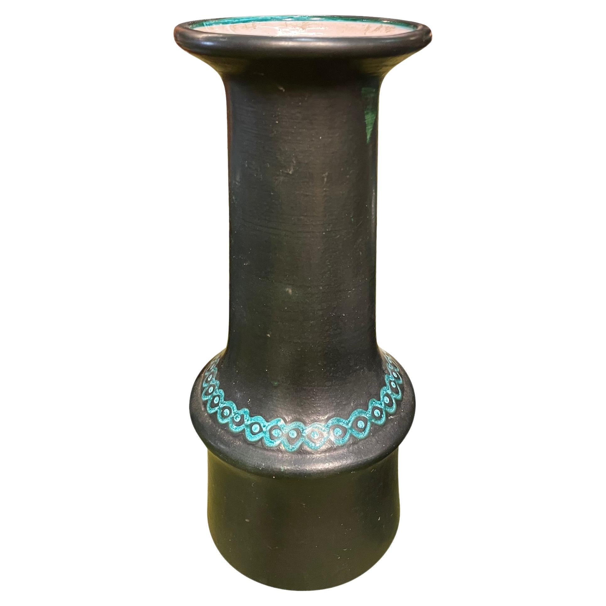 Italian Mid Century solid black glaze vase with turquoise decorative stripe detail.
From a collection of varying sizes and shapes.