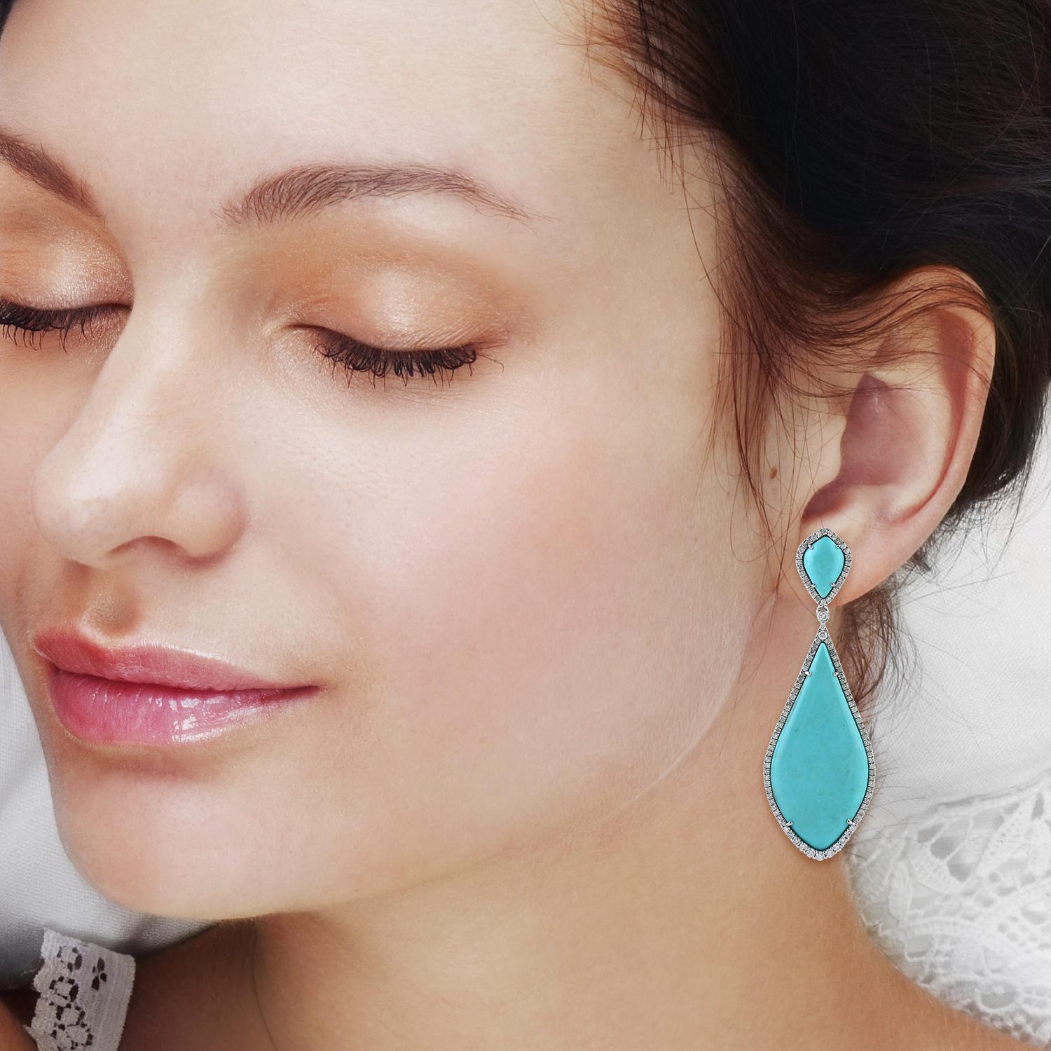 Handcrafted in radiant 14-karat gold, these extraordinary earrings are graced with 31.96 carats of vivid turquoise—each stone a tribute to nature’s artistry and centuries of reverence. Framed by 1.73 carats of luminous diamonds, they capture the