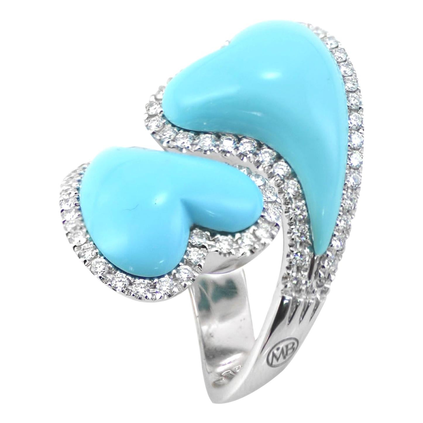 Handcrafted in Italy, in Margherita Burgener workshop, the toi et moi Hearts ring and matching pair of clip earrings is an elegant set realized in 18Kt white gold, set with diamonds to highlight  the bombé natural turquoise hearts.

Earrings
18KT